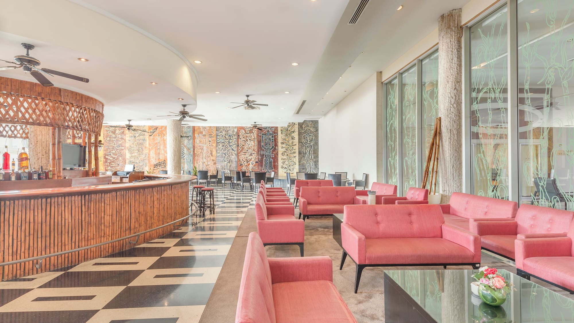 a room with pink couches and a black and white checkered floor