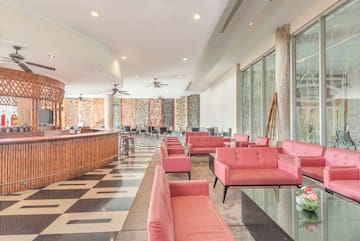 a room with pink couches and a black and white checkered floor
