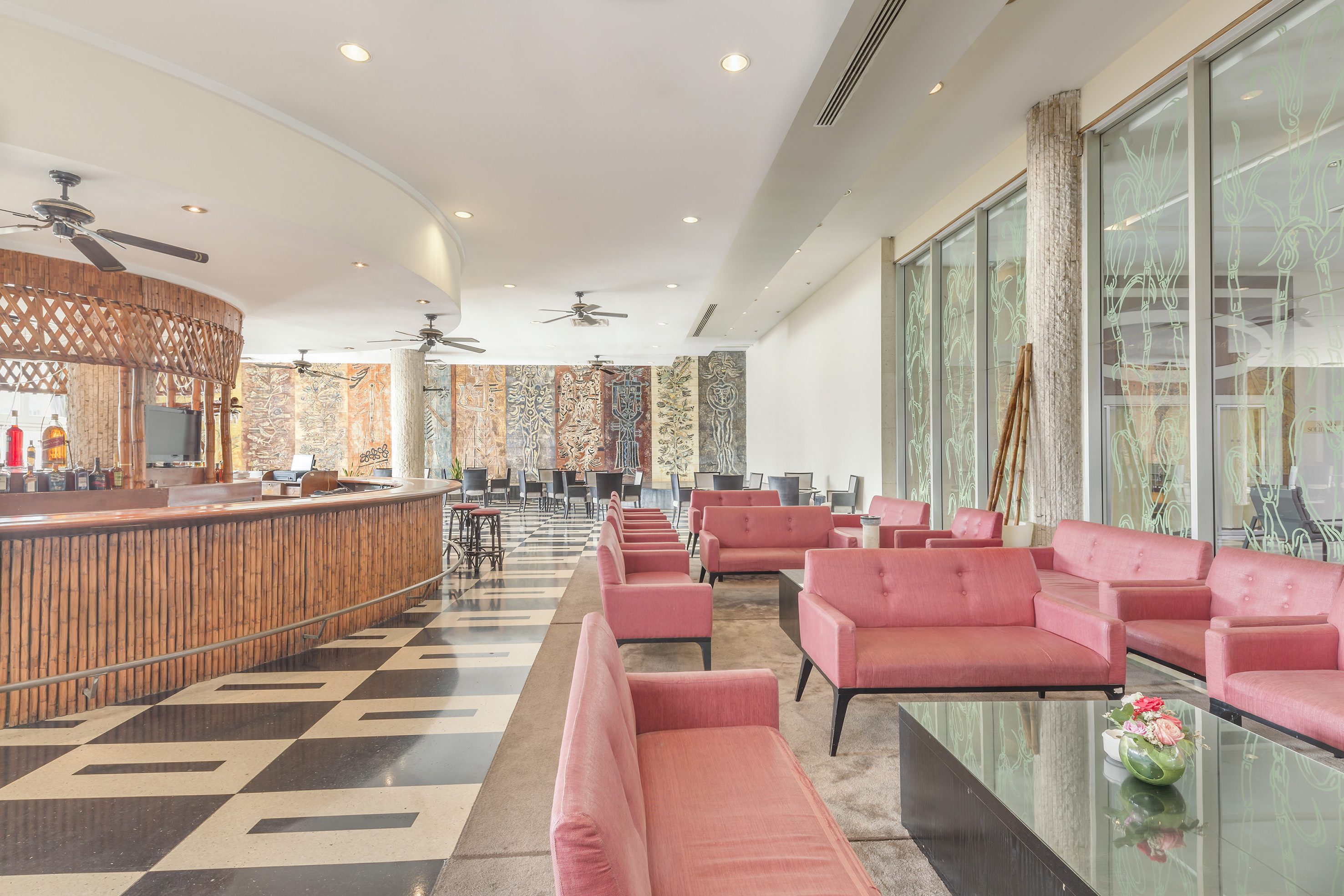 a room with pink couches and a black and white checkered floor