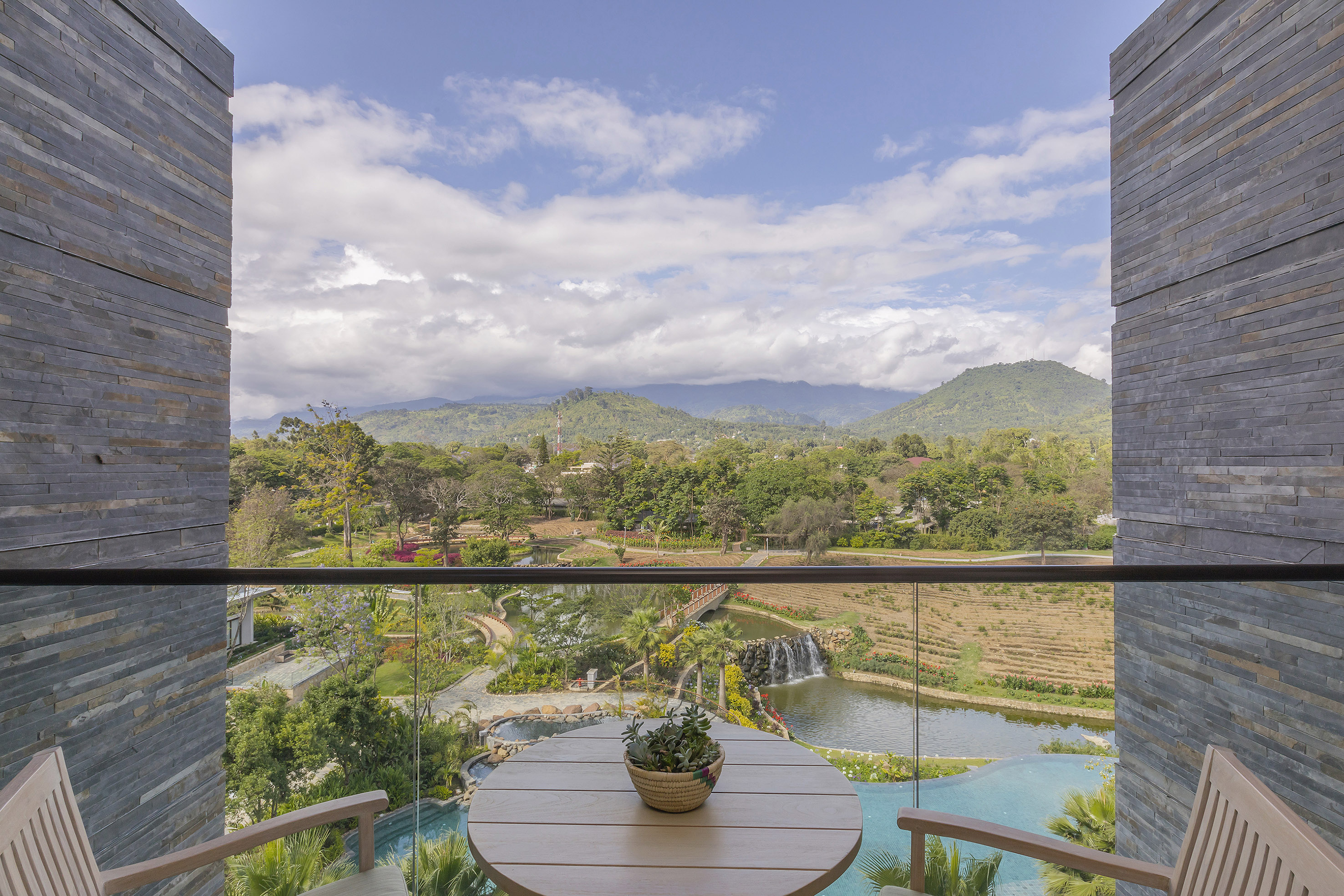 a balcony with a view of a river and mountains