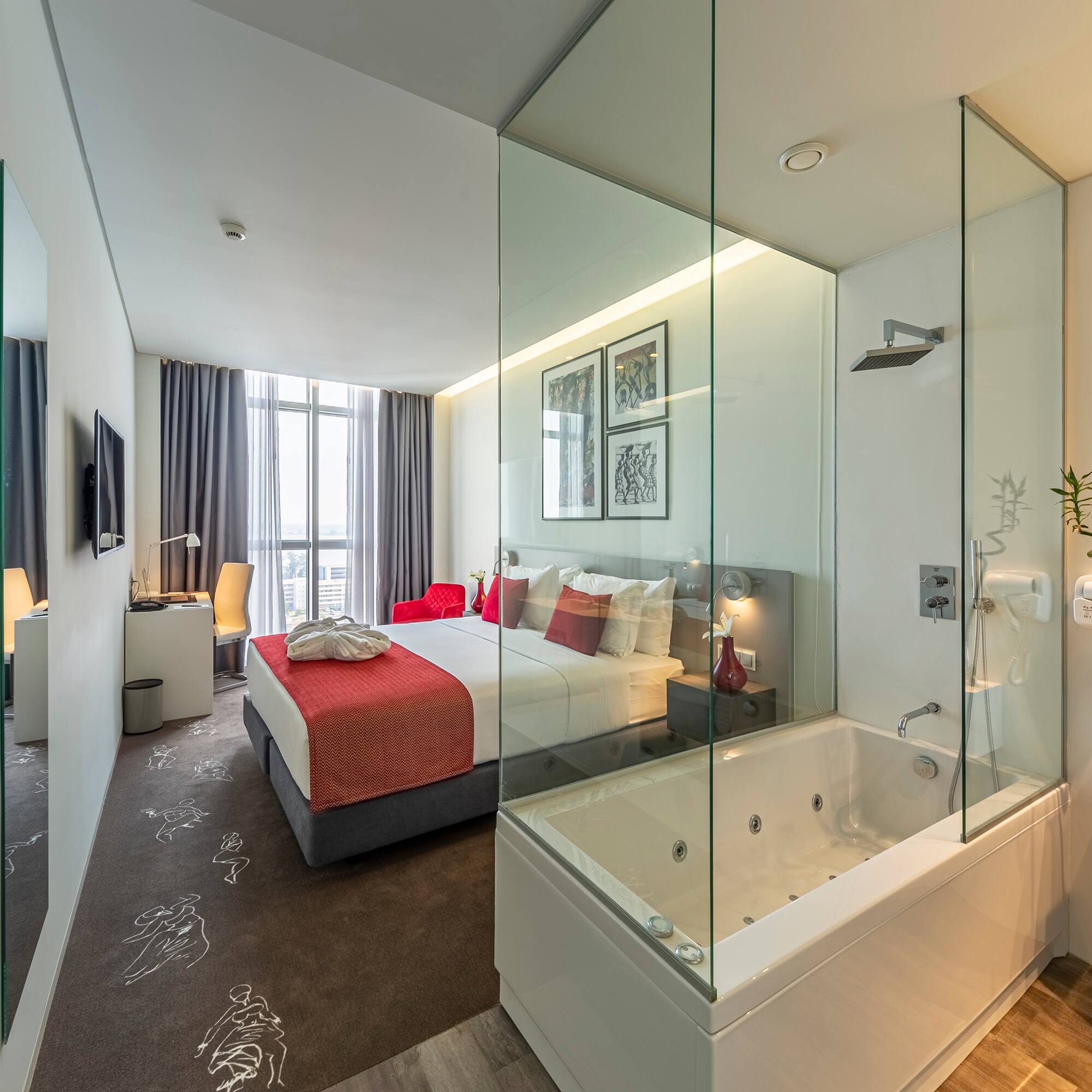 a bedroom with a glass shower and a bed