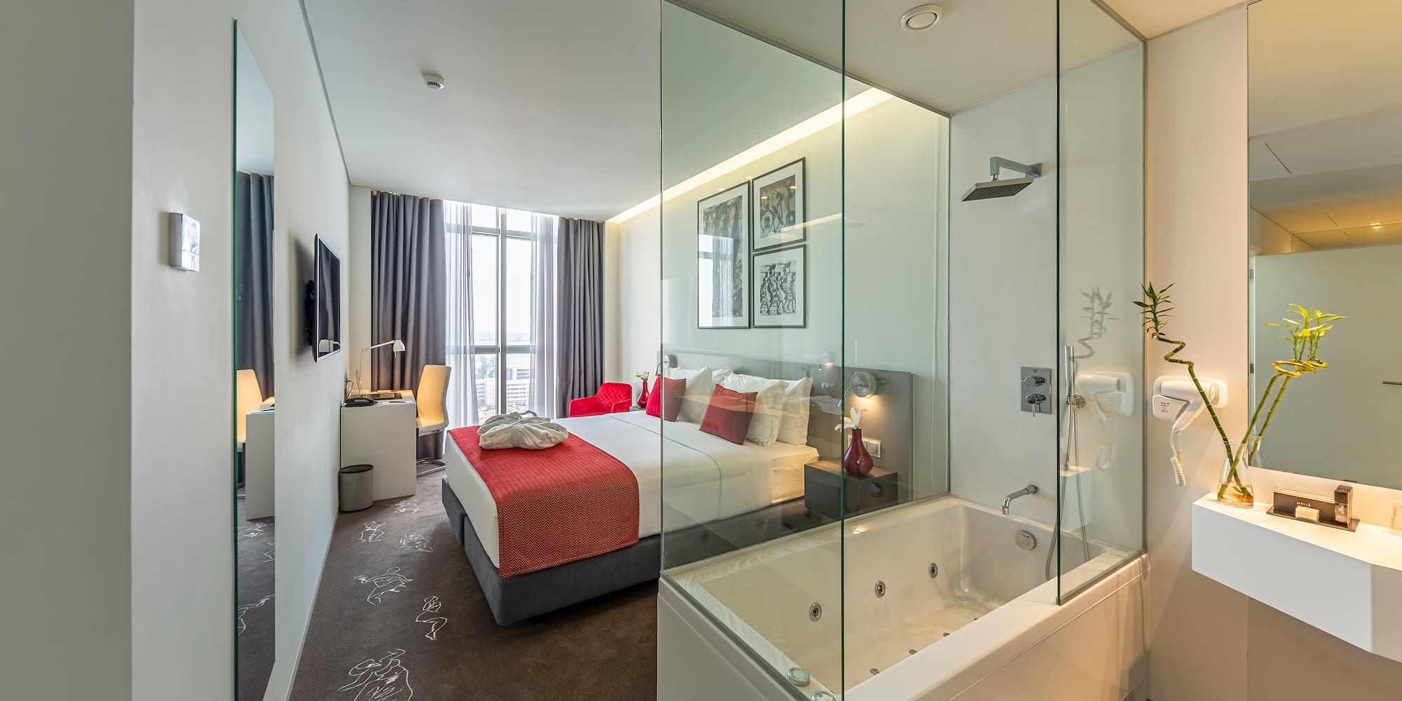 a bedroom with a glass shower and a bed