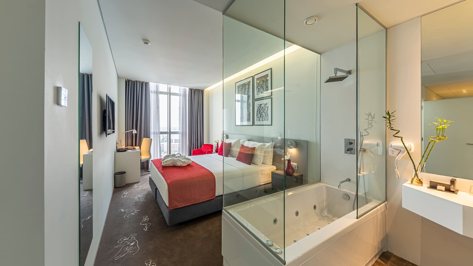 a bedroom with a glass shower and a bed