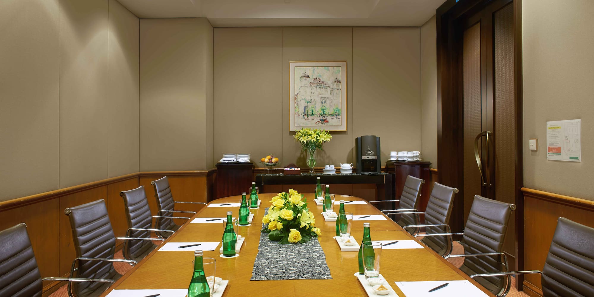 a table with green bottles and flowers on it