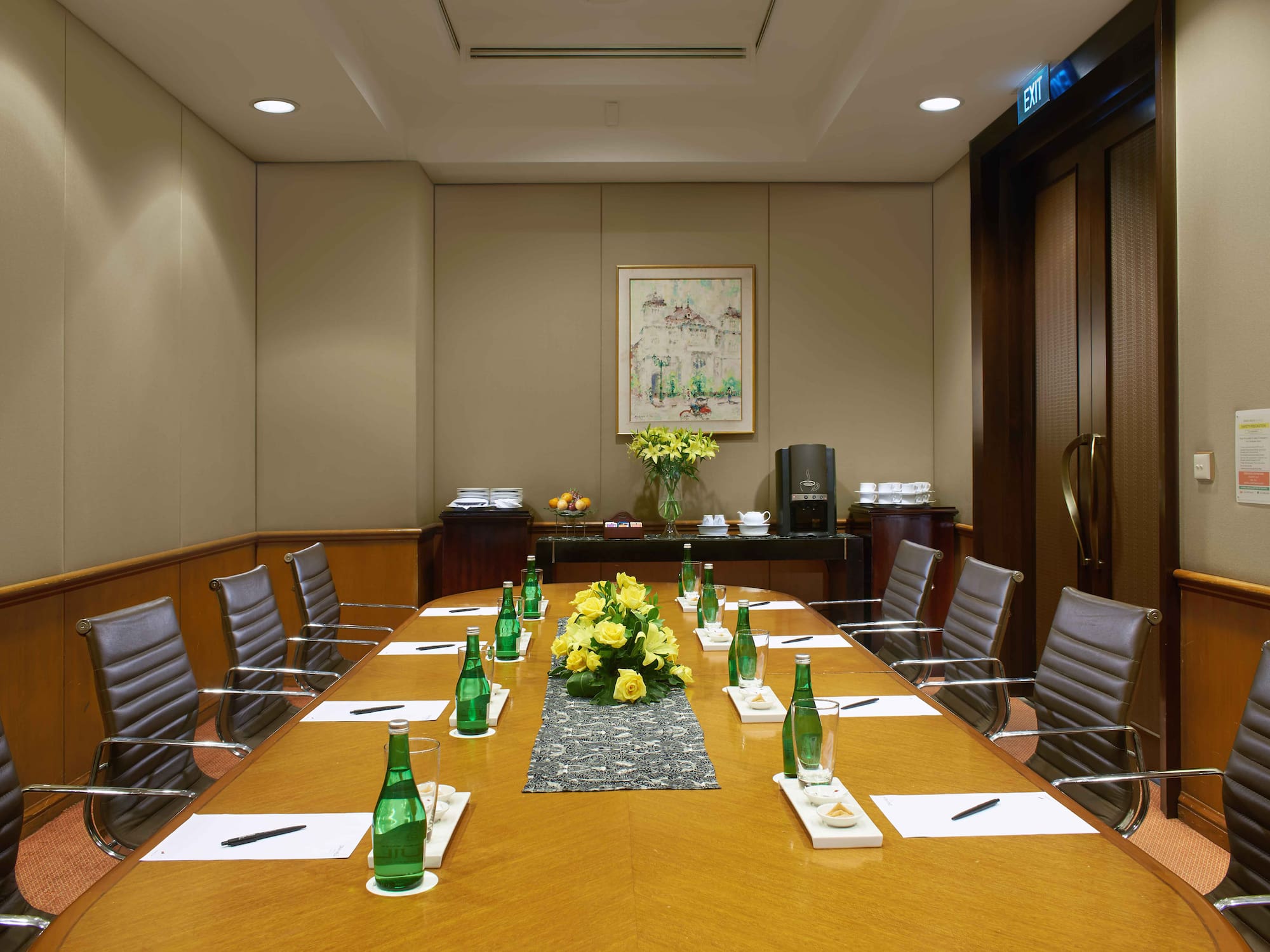 a table with green bottles and flowers on it