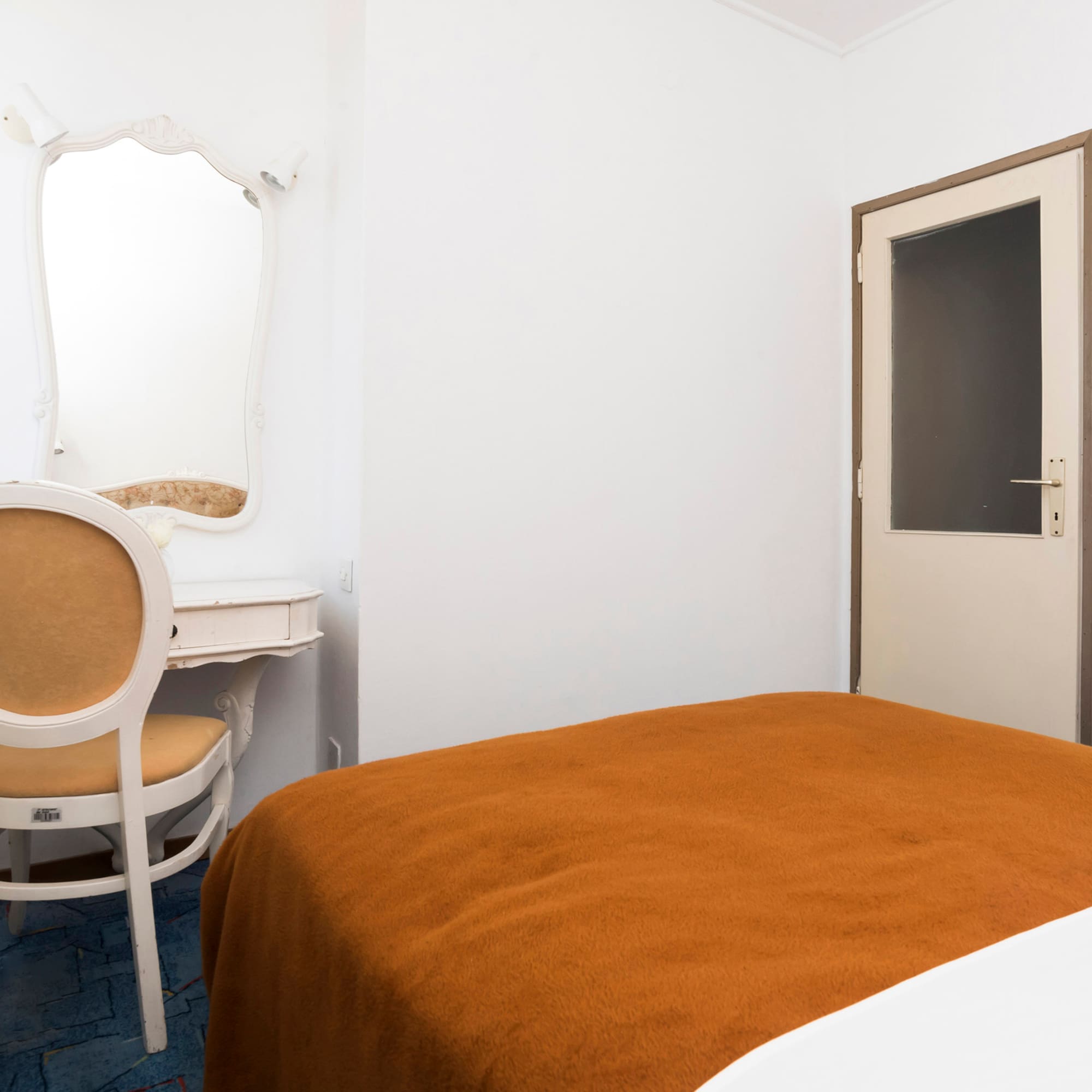 a room with a bed and a chair