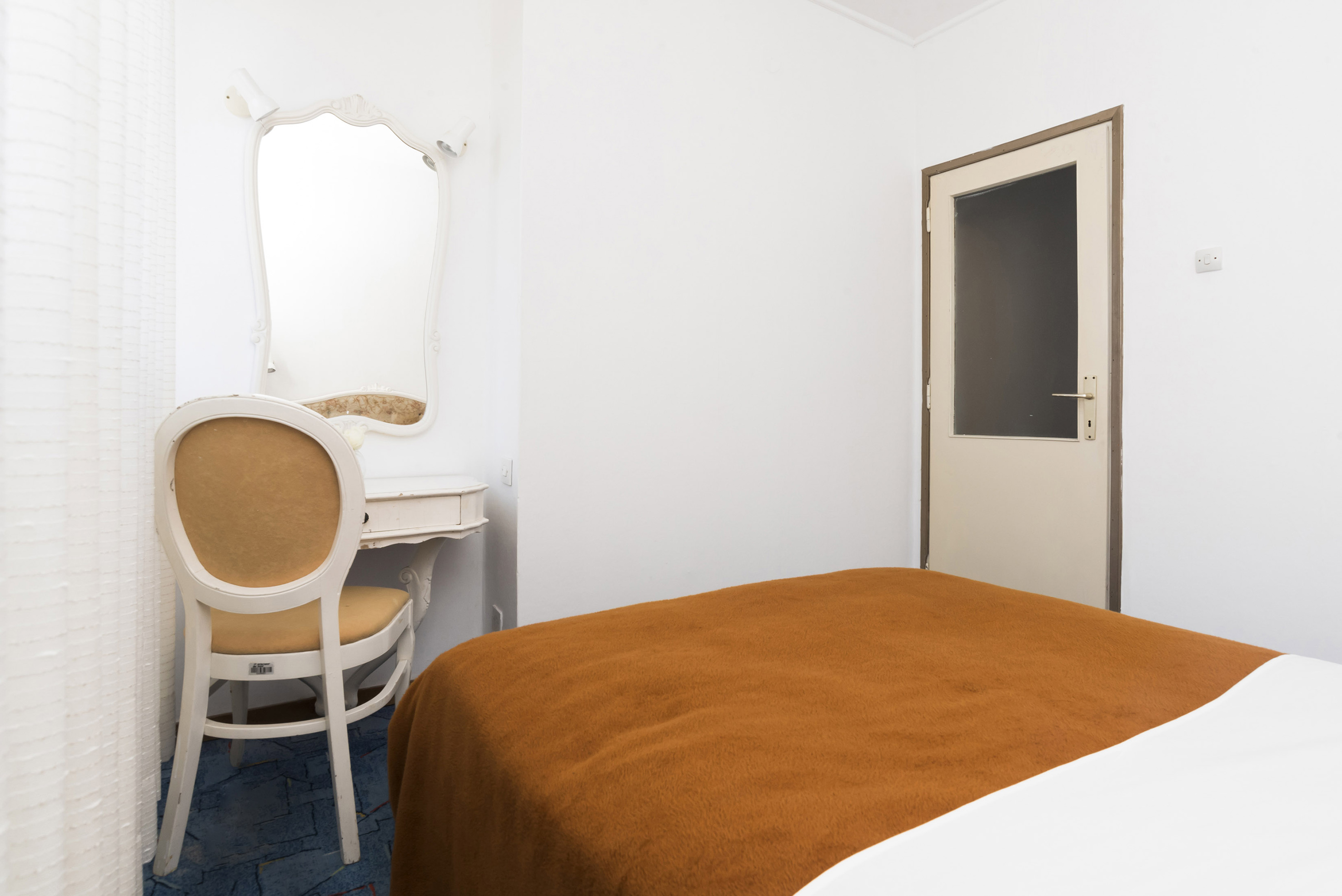 a room with a bed and a chair