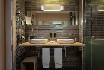 a bathroom with two sinks and a mirror
