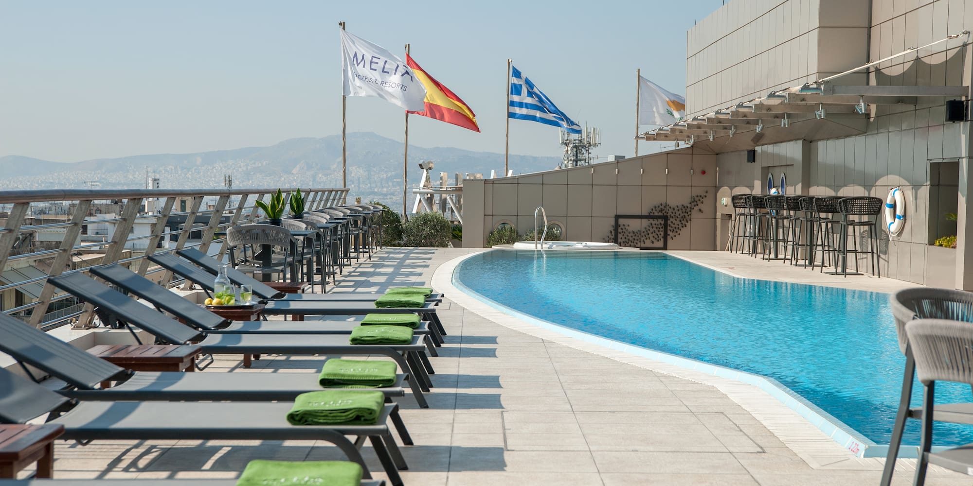 a pool with chairs and flags