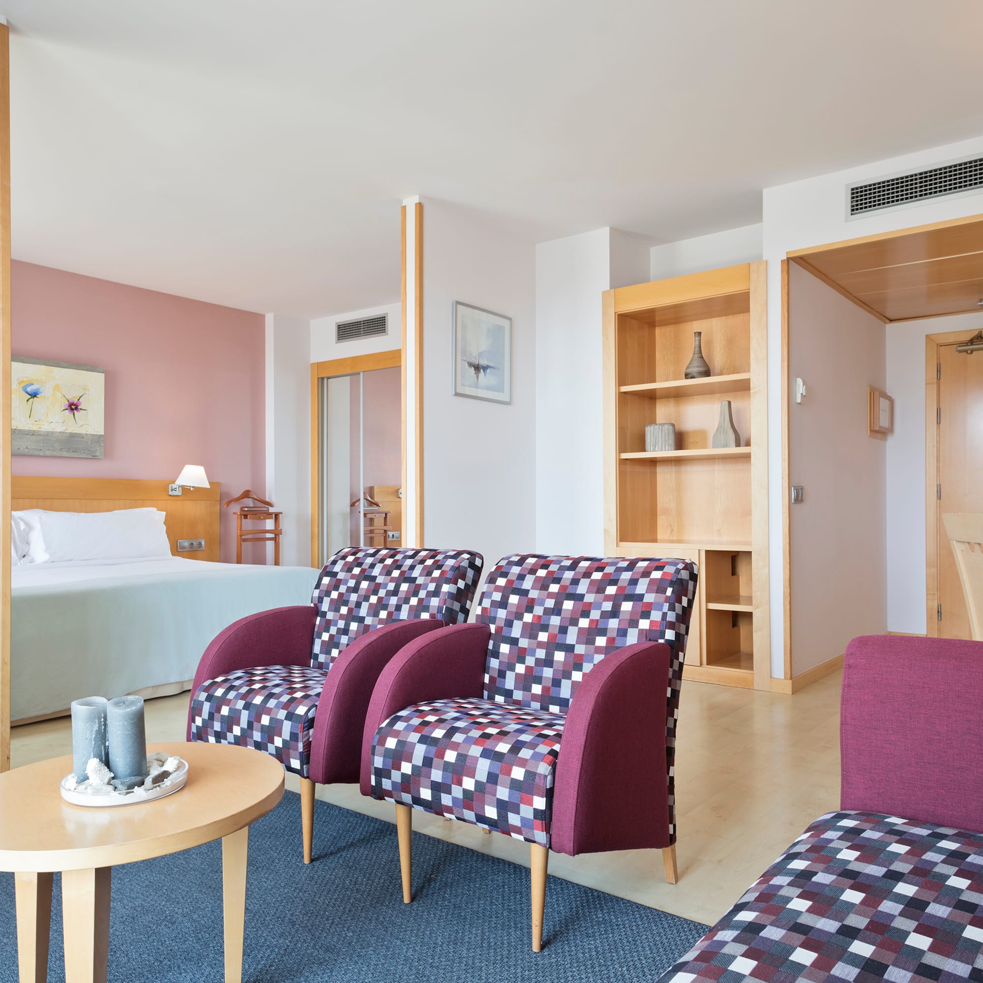 a room with purple chairs and a table