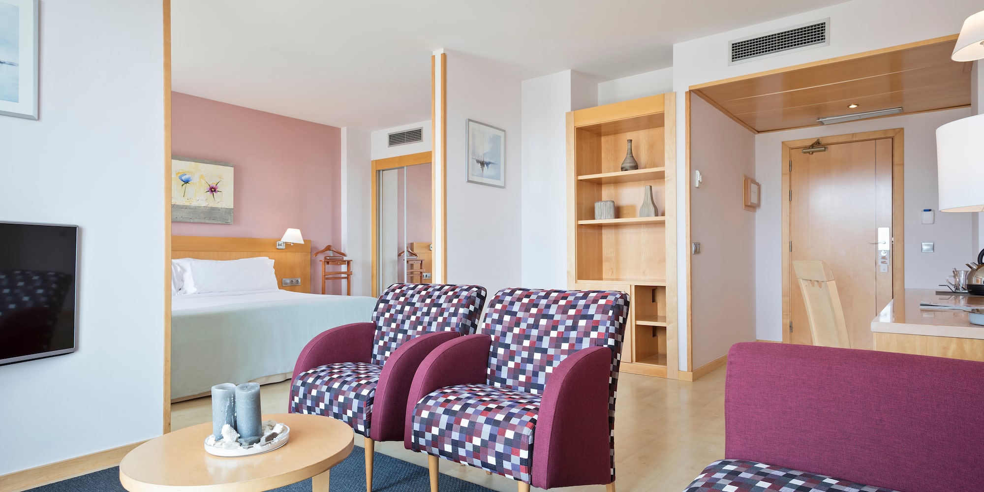 a room with purple chairs and a table