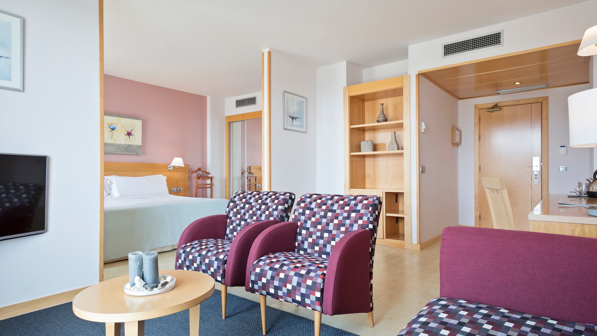 a room with purple chairs and a table