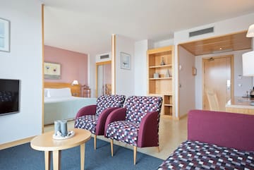 a room with purple chairs and a table
