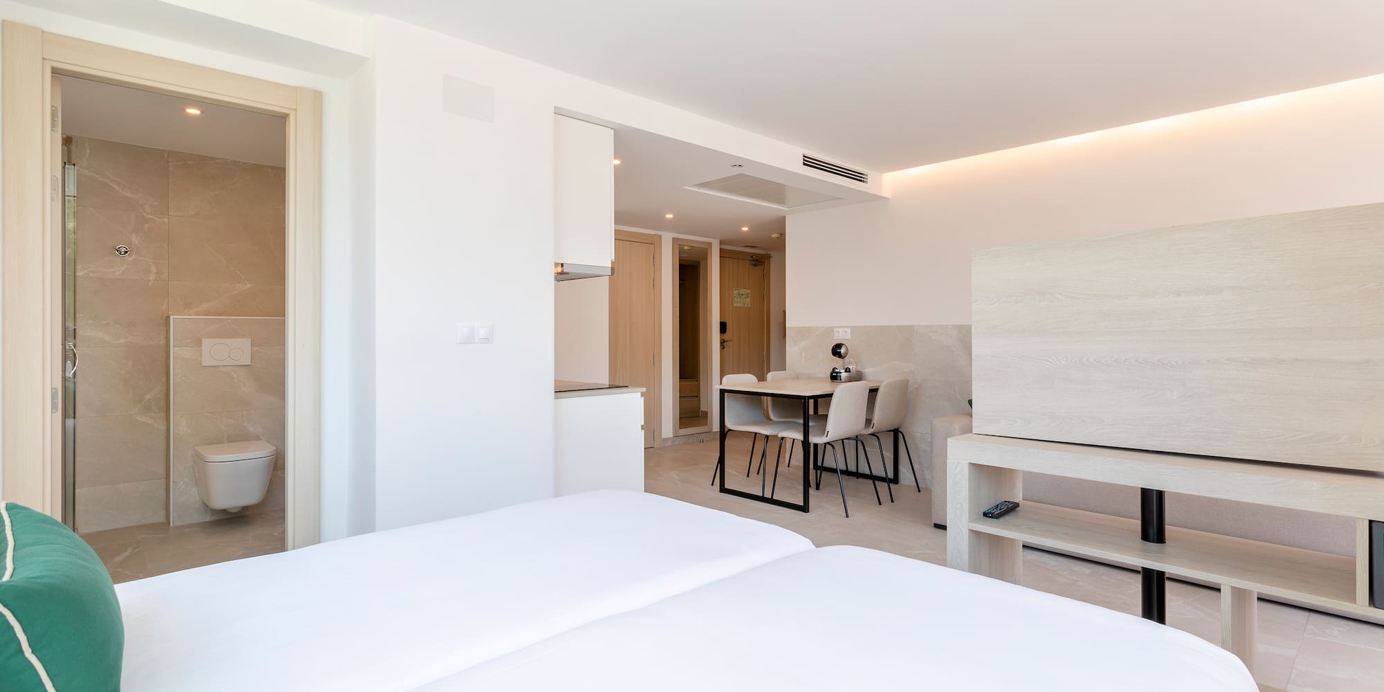 a room with a bed and a toilet