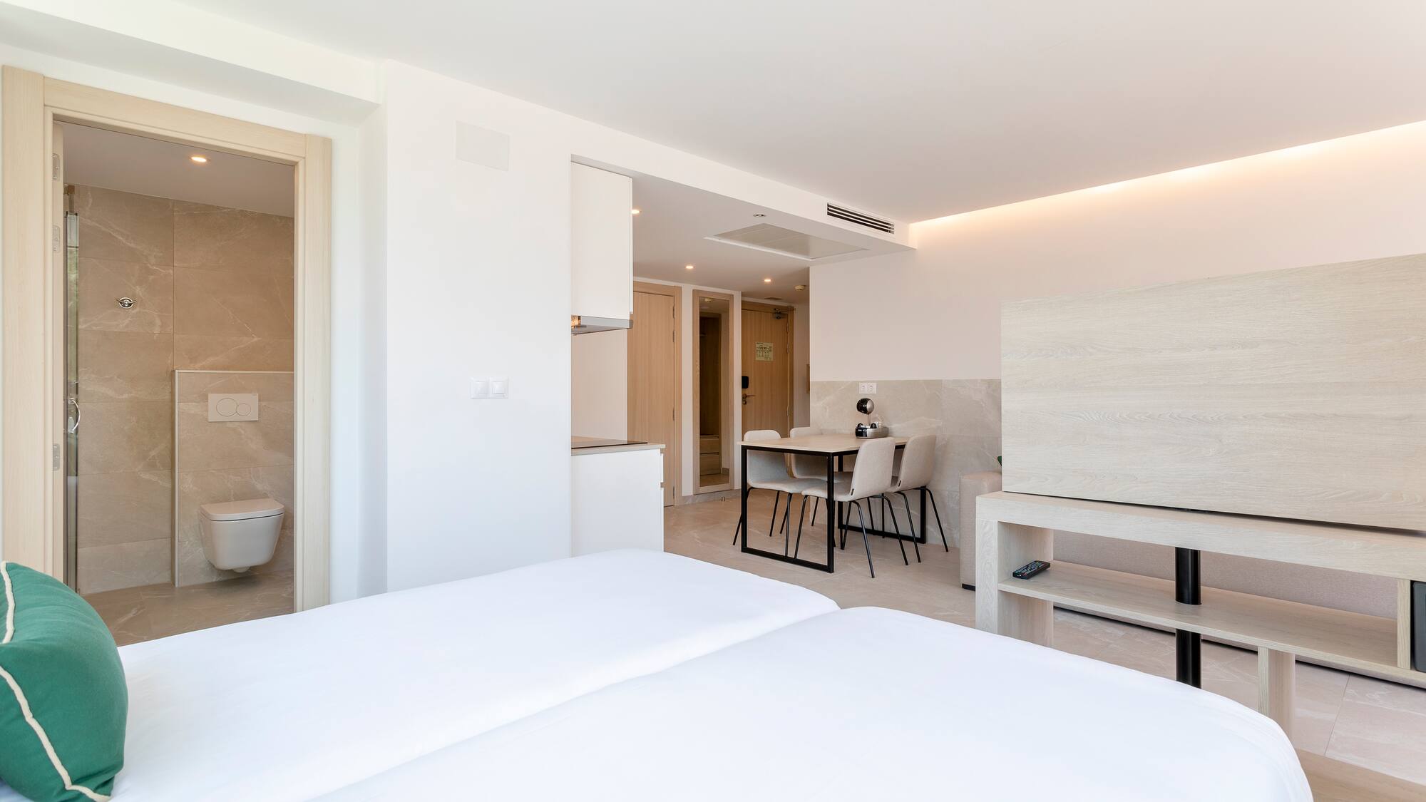 a room with a bed and a toilet