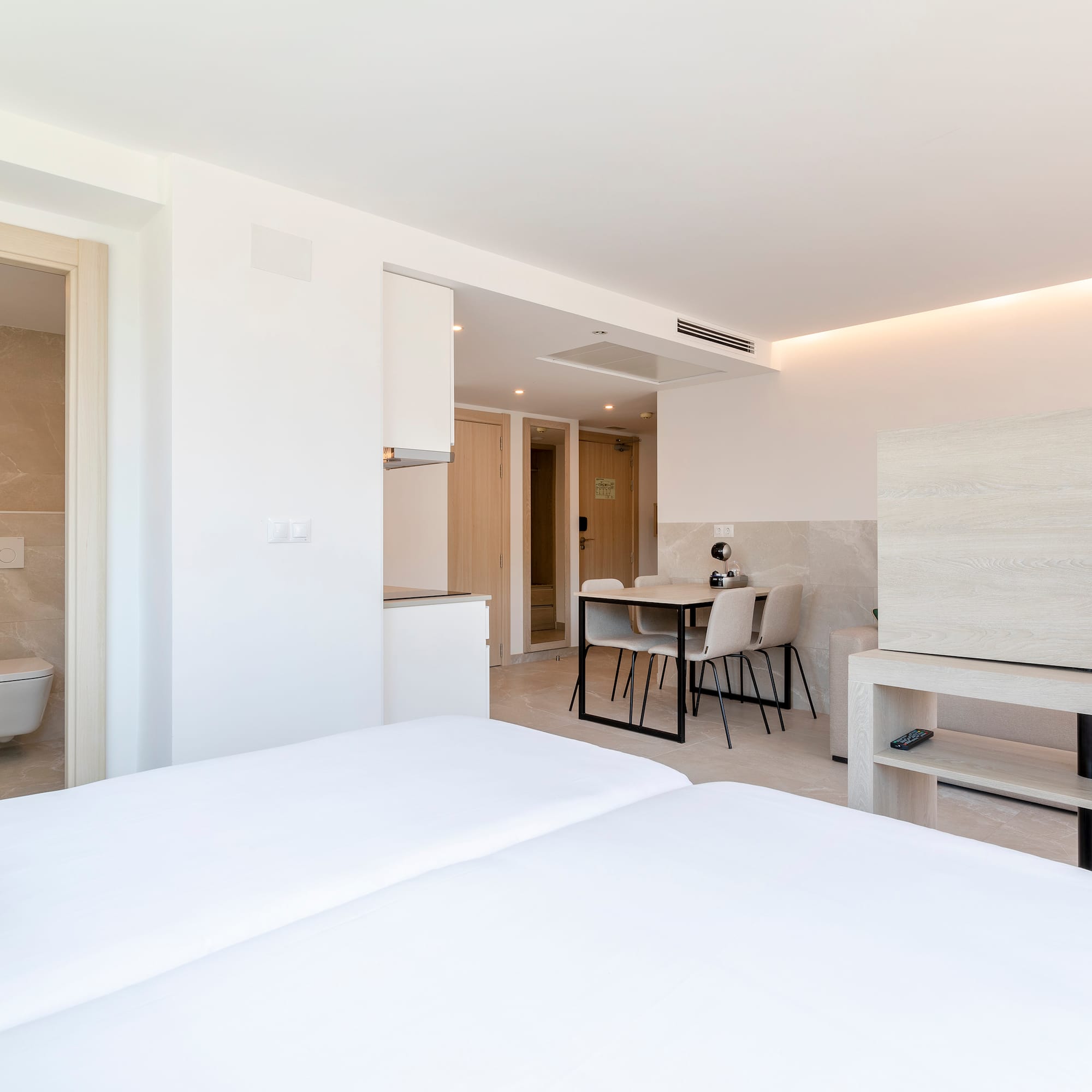 a room with a bed and a toilet