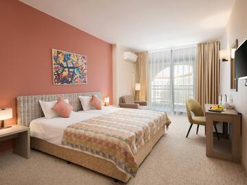 a bedroom with a bed and a desk