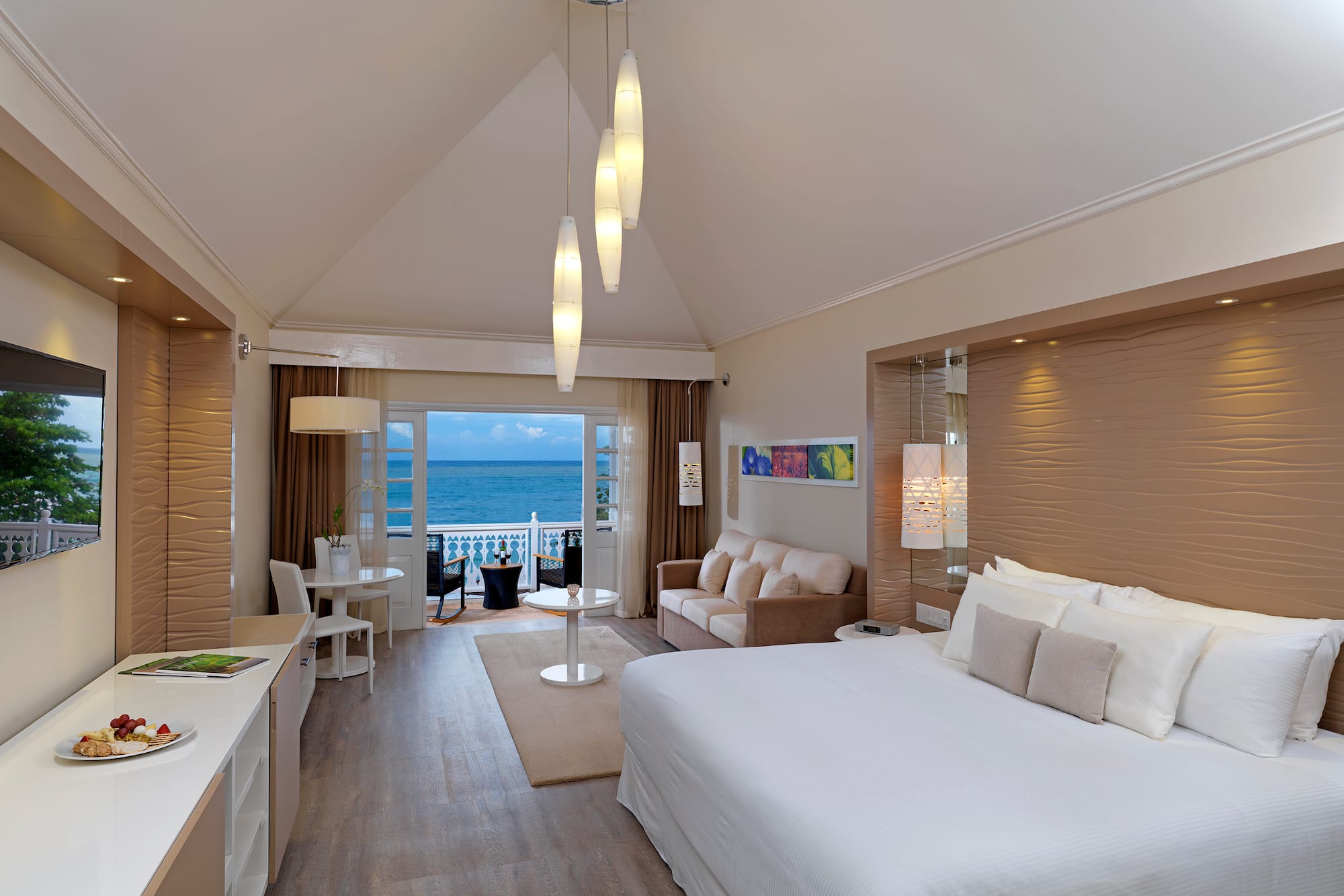 a room with a bed and a table and chairs