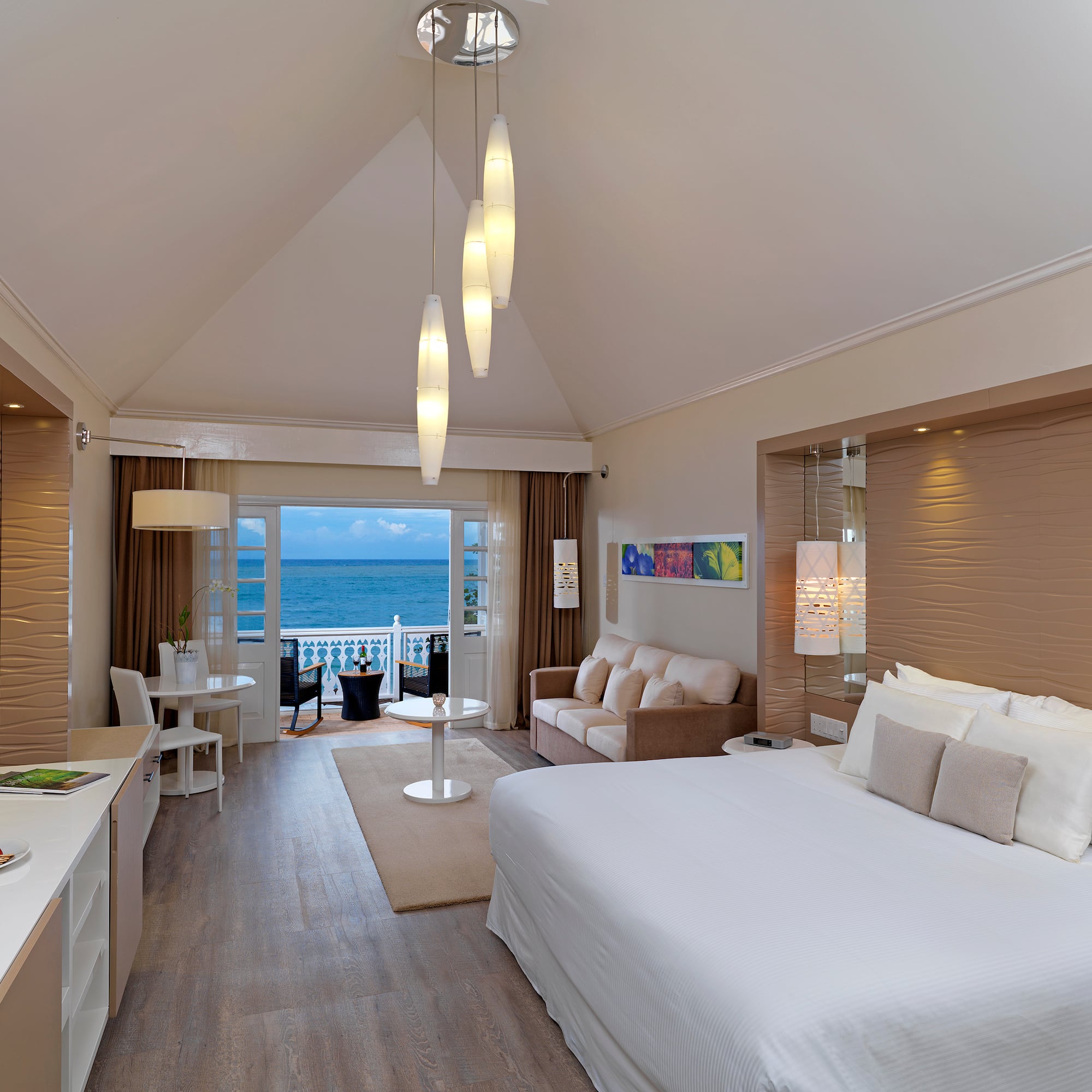 a room with a bed and a table and chairs