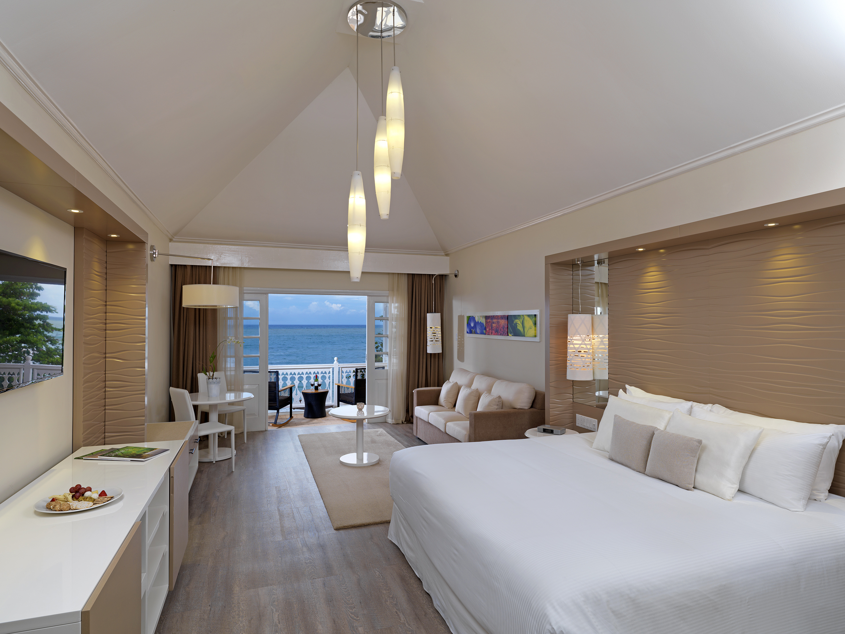 a room with a bed and a table and chairs