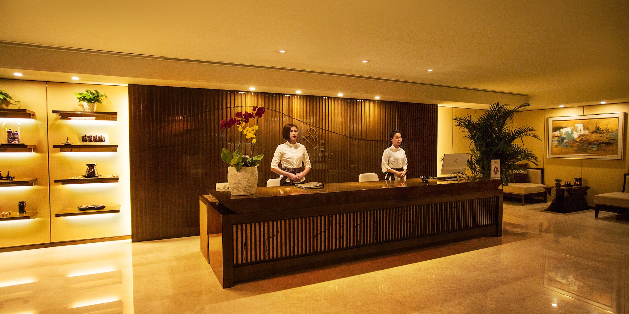 a couple of people standing at a reception desk