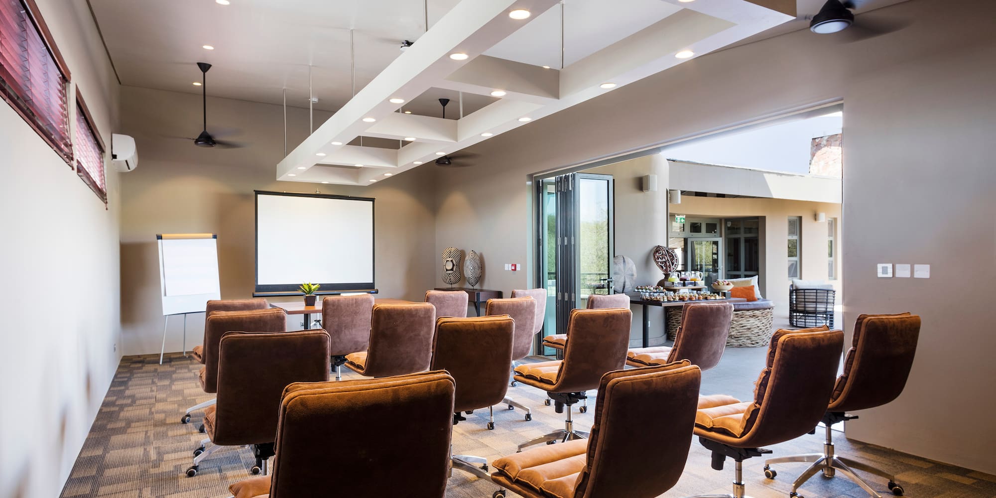 a room with chairs and a projector screen