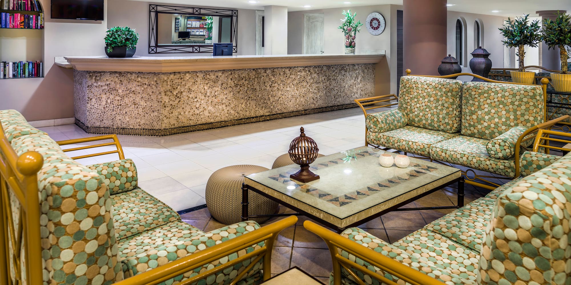 a lobby with a reception desk and chairs
