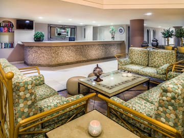 a lobby with a reception desk and chairs