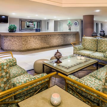 a lobby with a reception desk and chairs