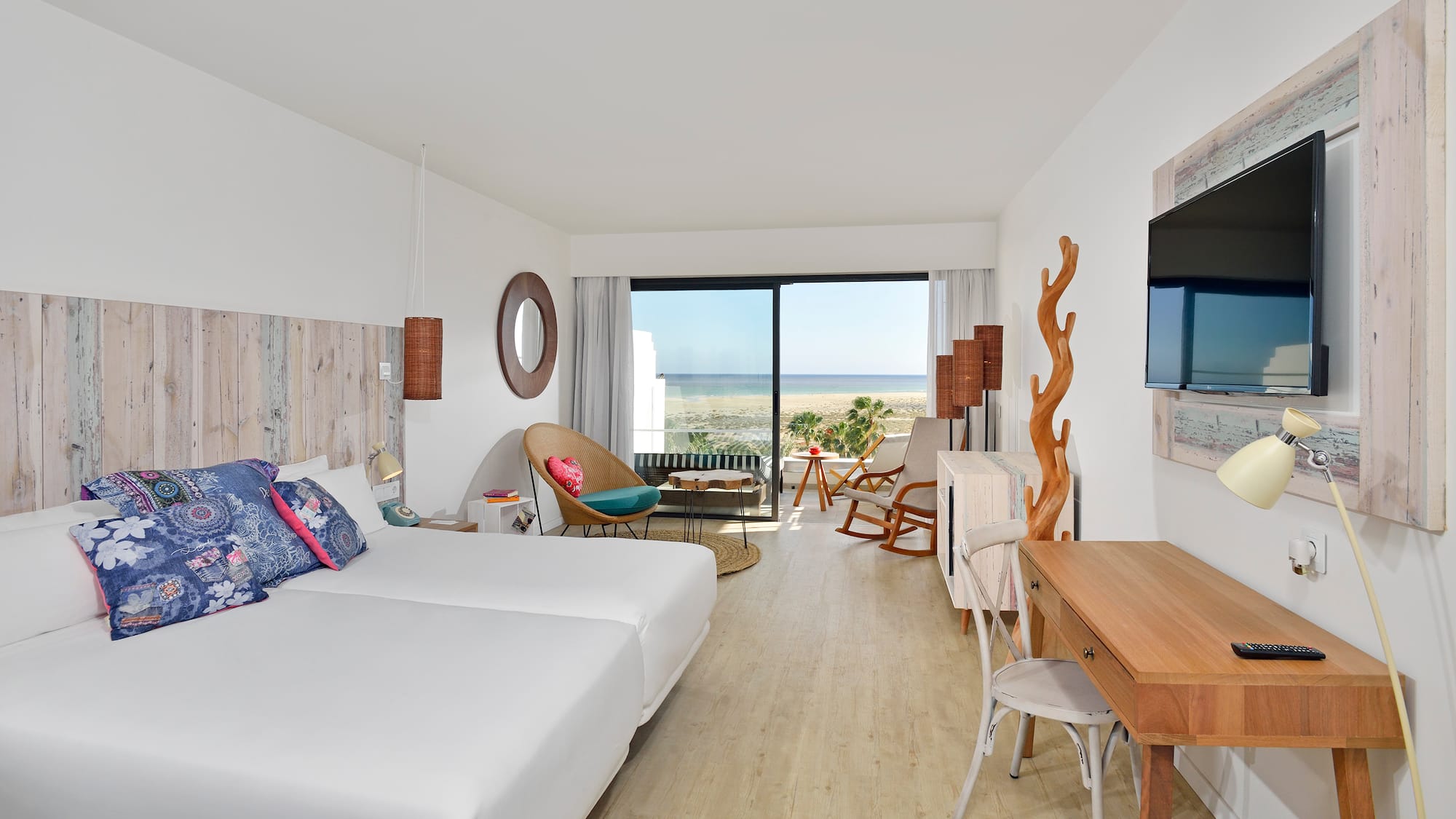 a room with two beds and a television