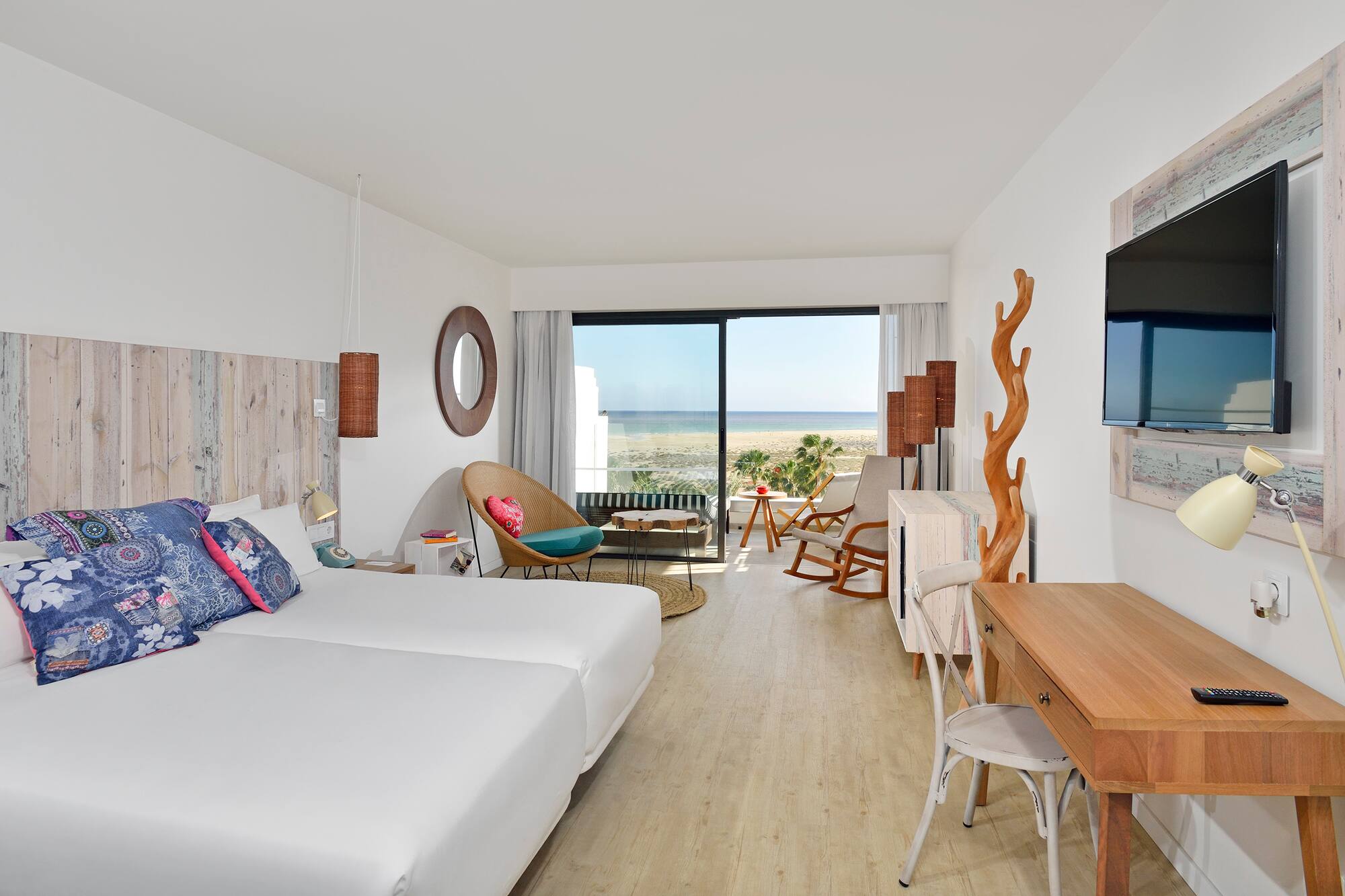 a room with two beds and a television