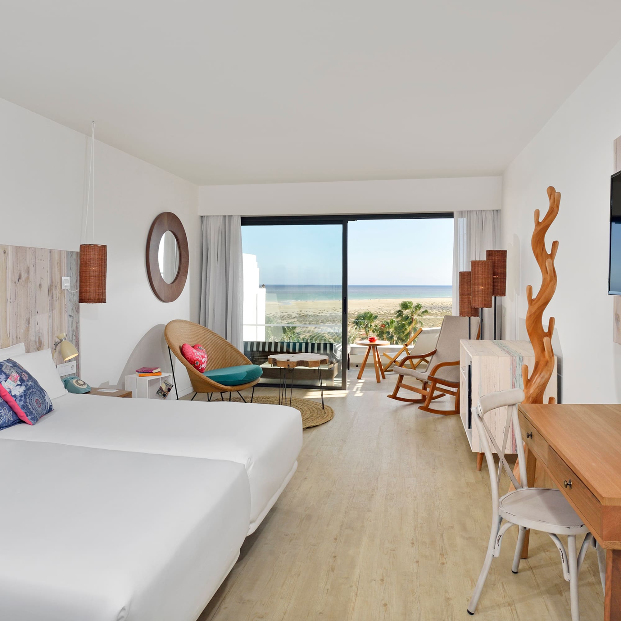 a room with two beds and a television