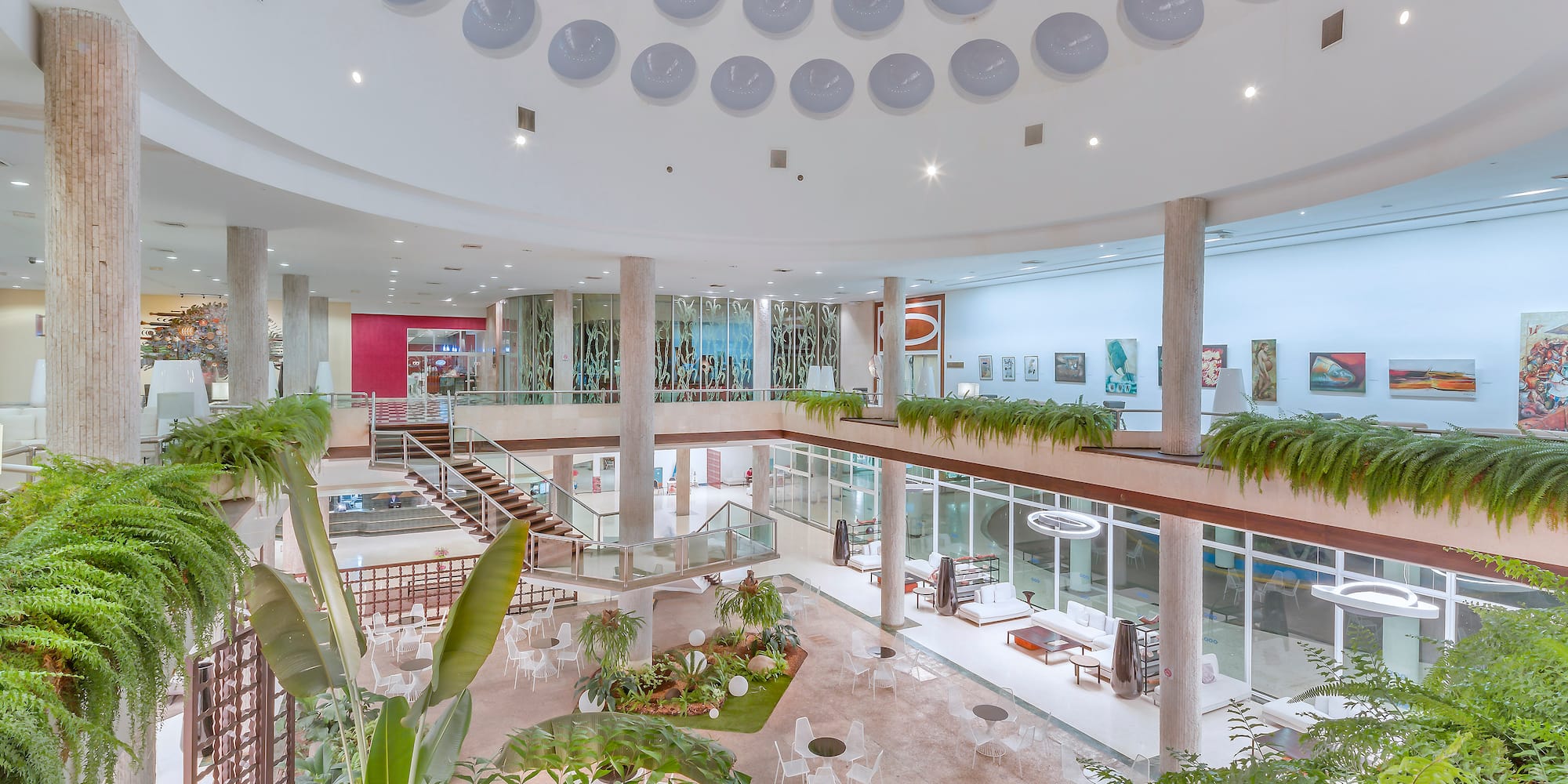 a large building with many floors and plants