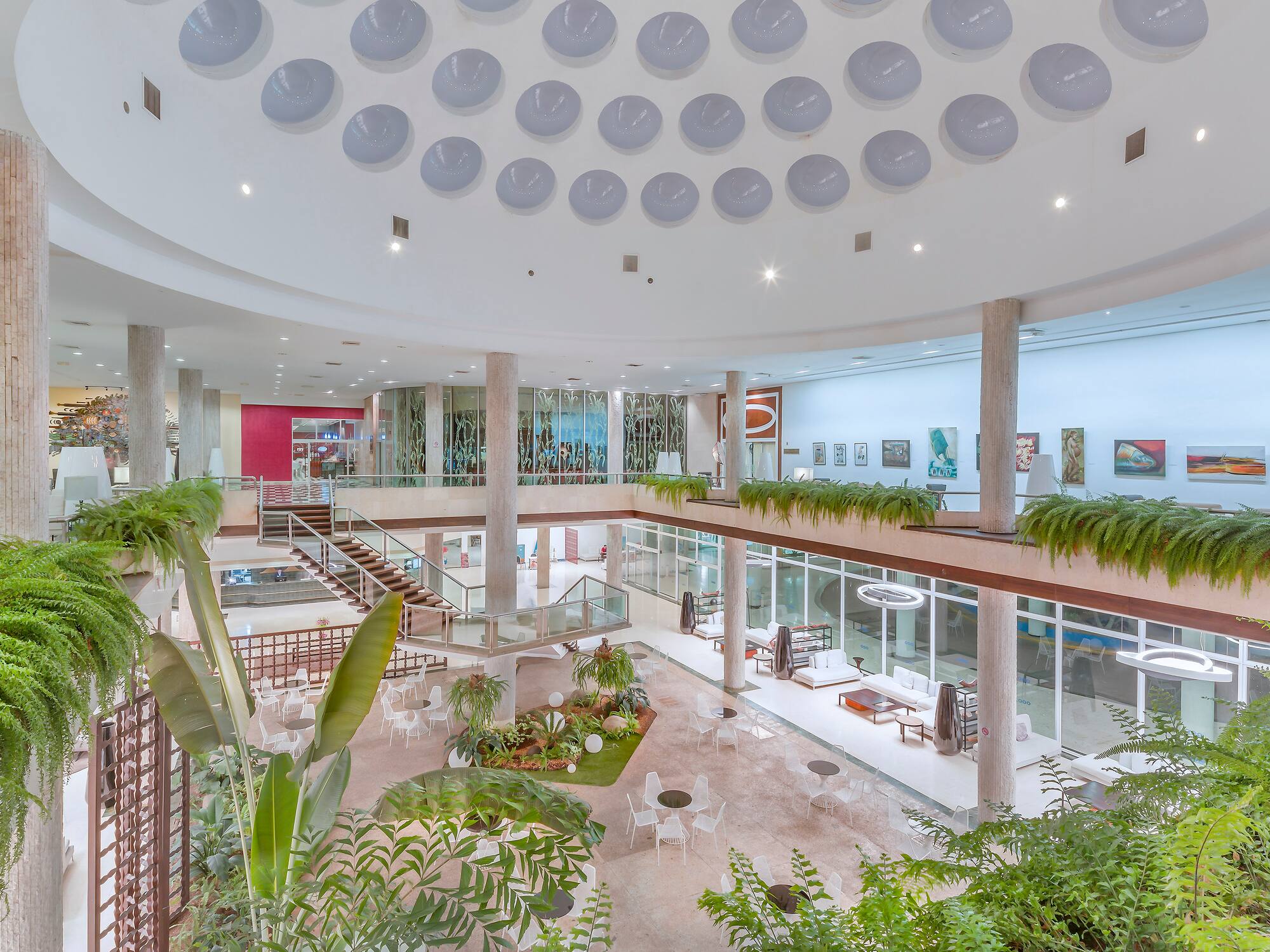 a large building with many floors and plants