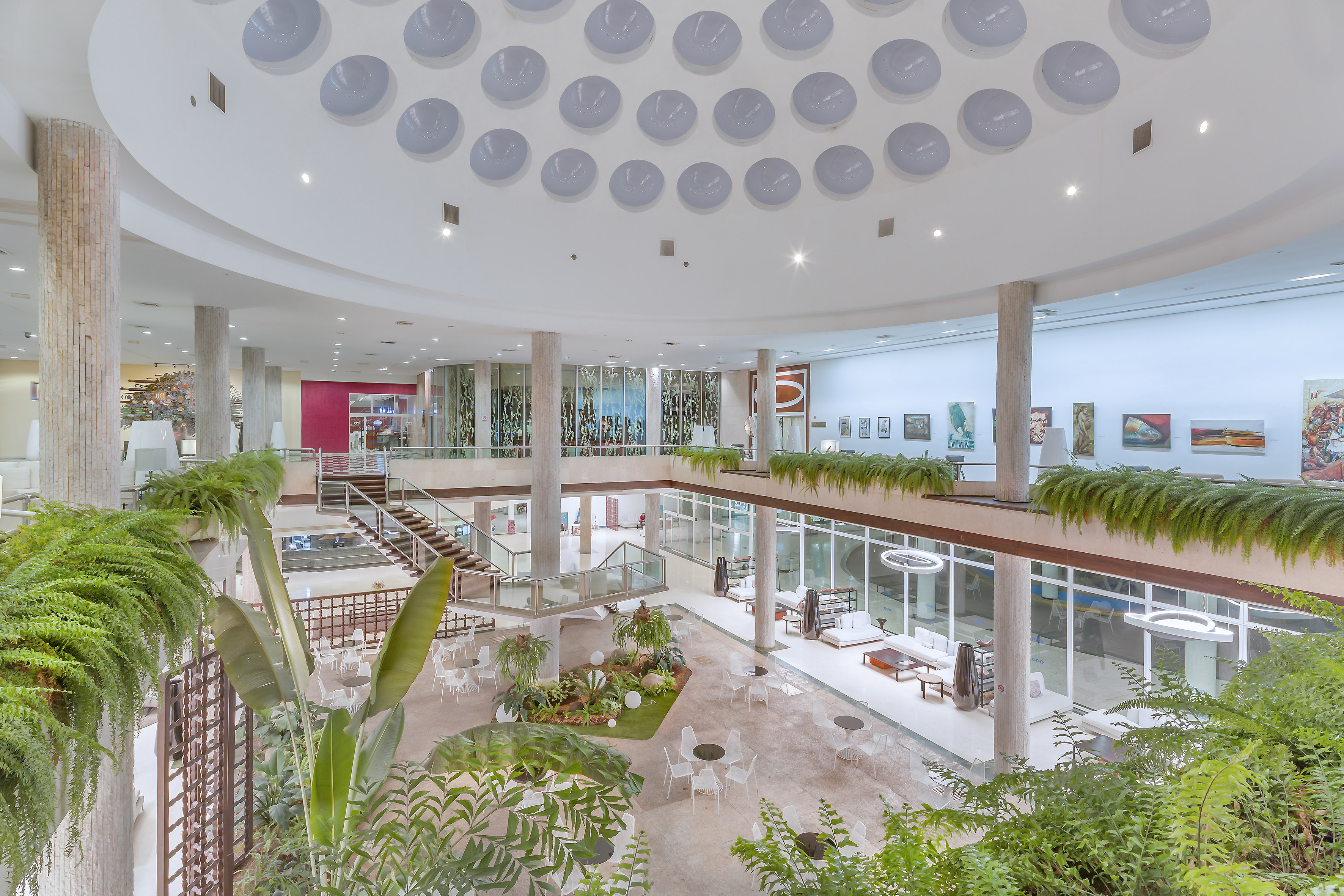 a large building with many floors and plants