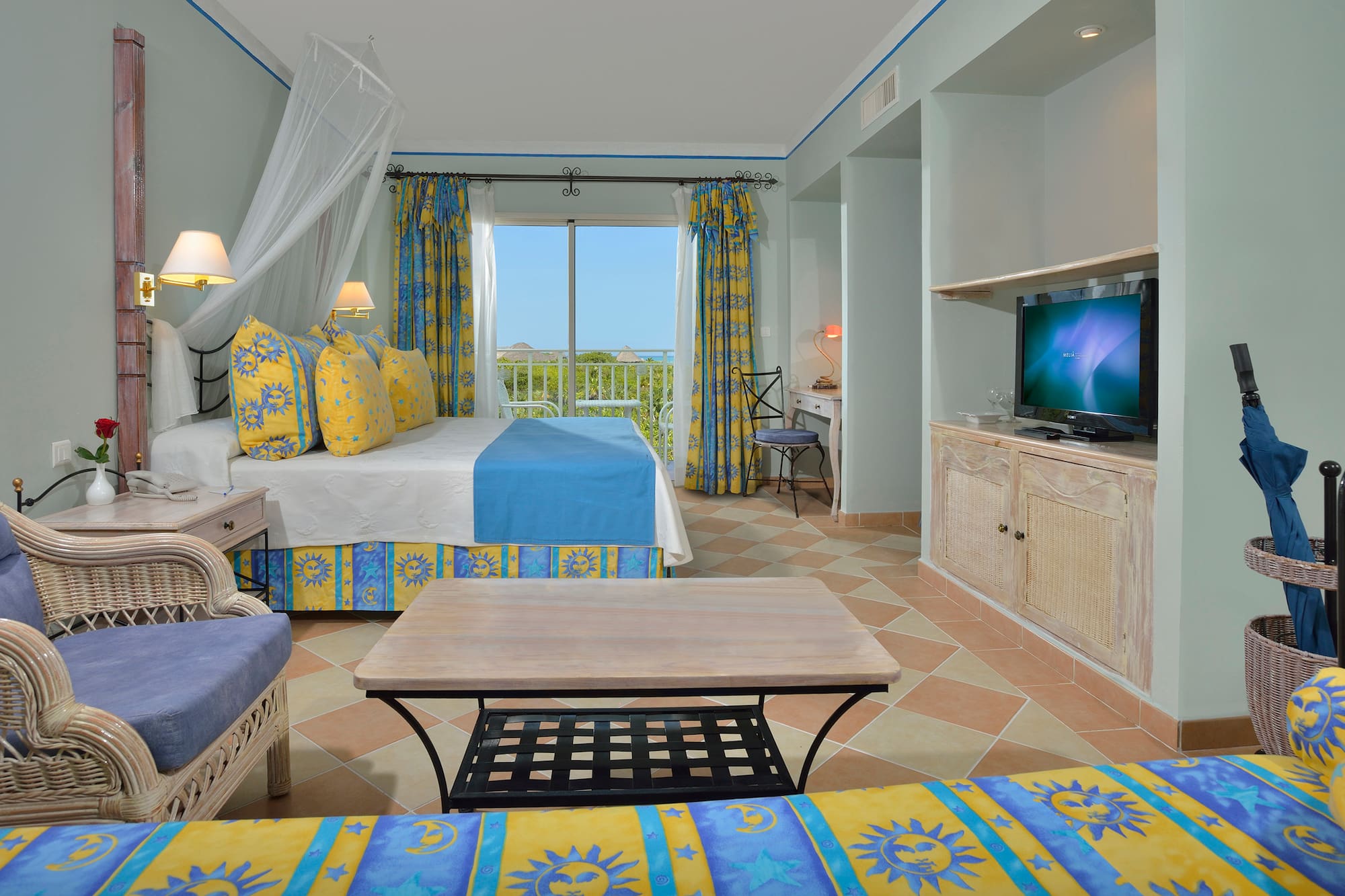 a room with a bed and a television