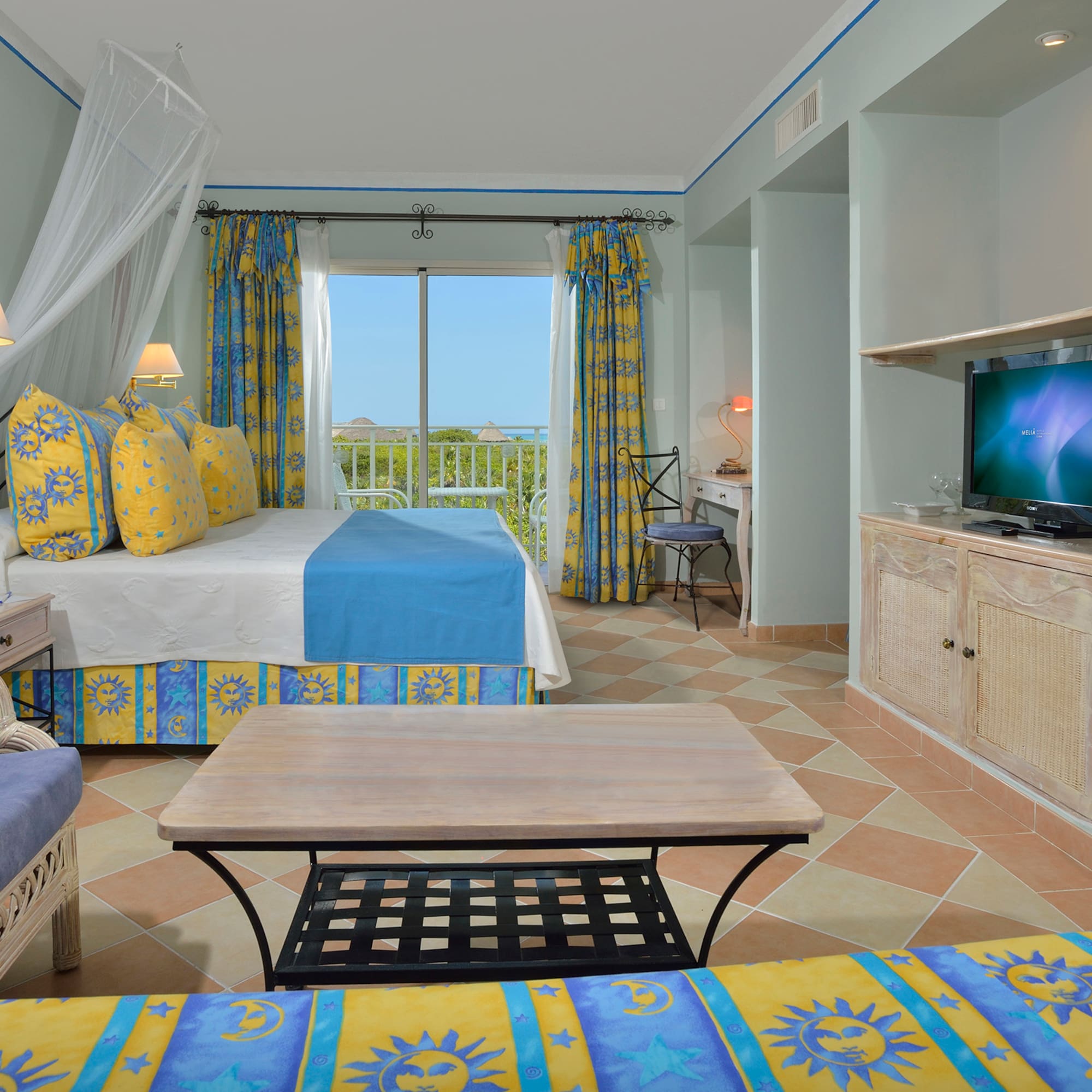 a room with a bed and a television