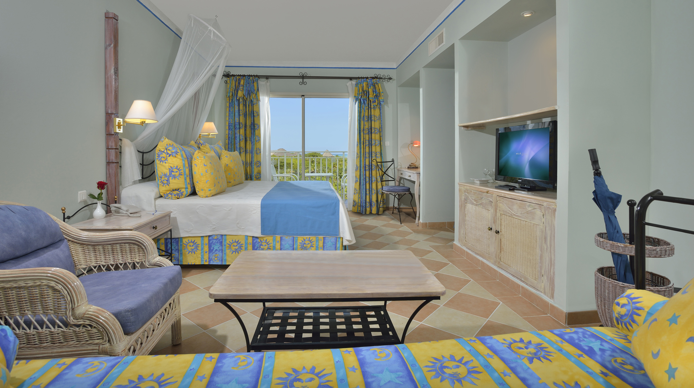 a room with a bed and a television