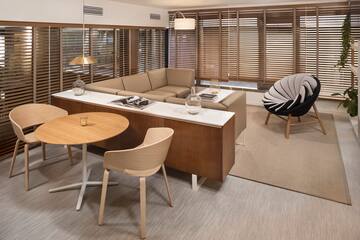 a room with a couch and chairs