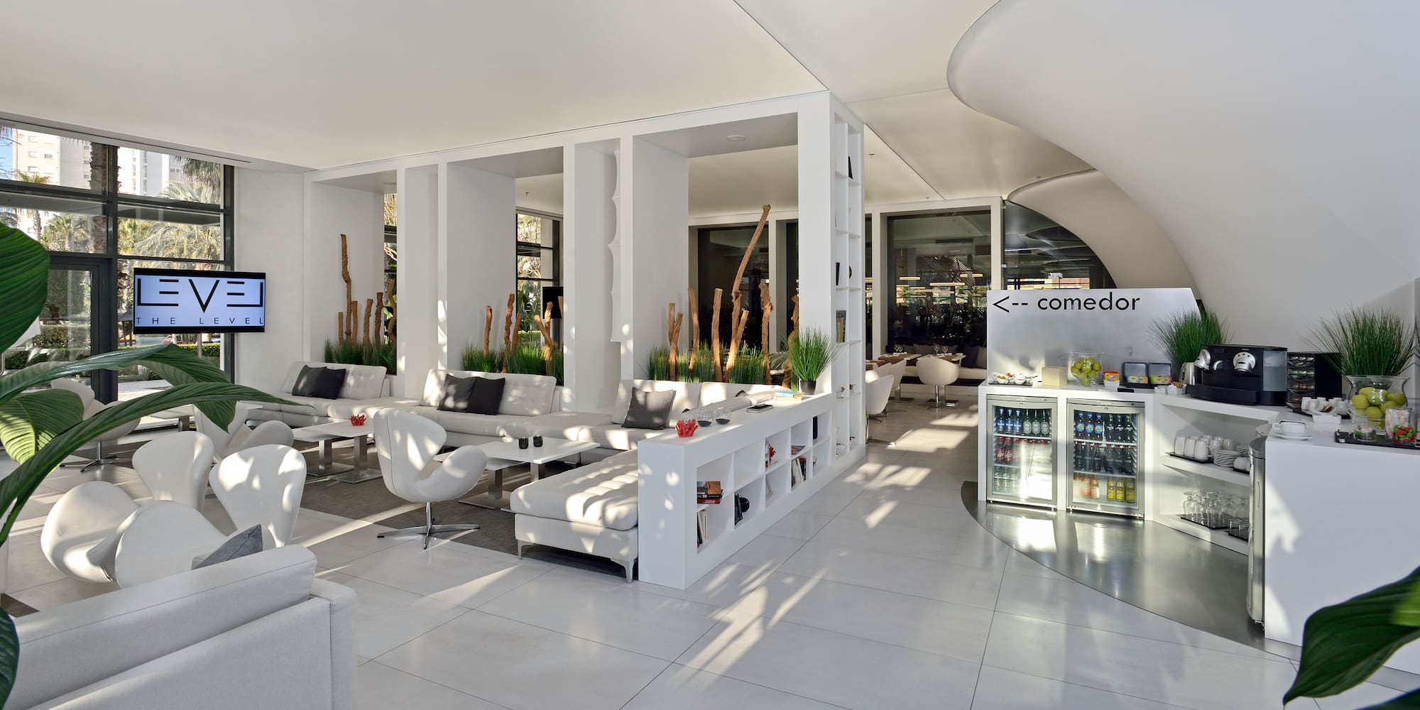 a room with white furniture and a white wall