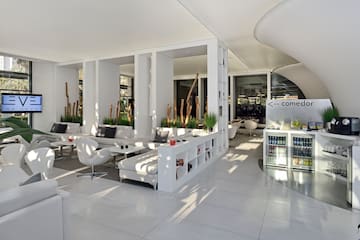 a room with white furniture and a white wall