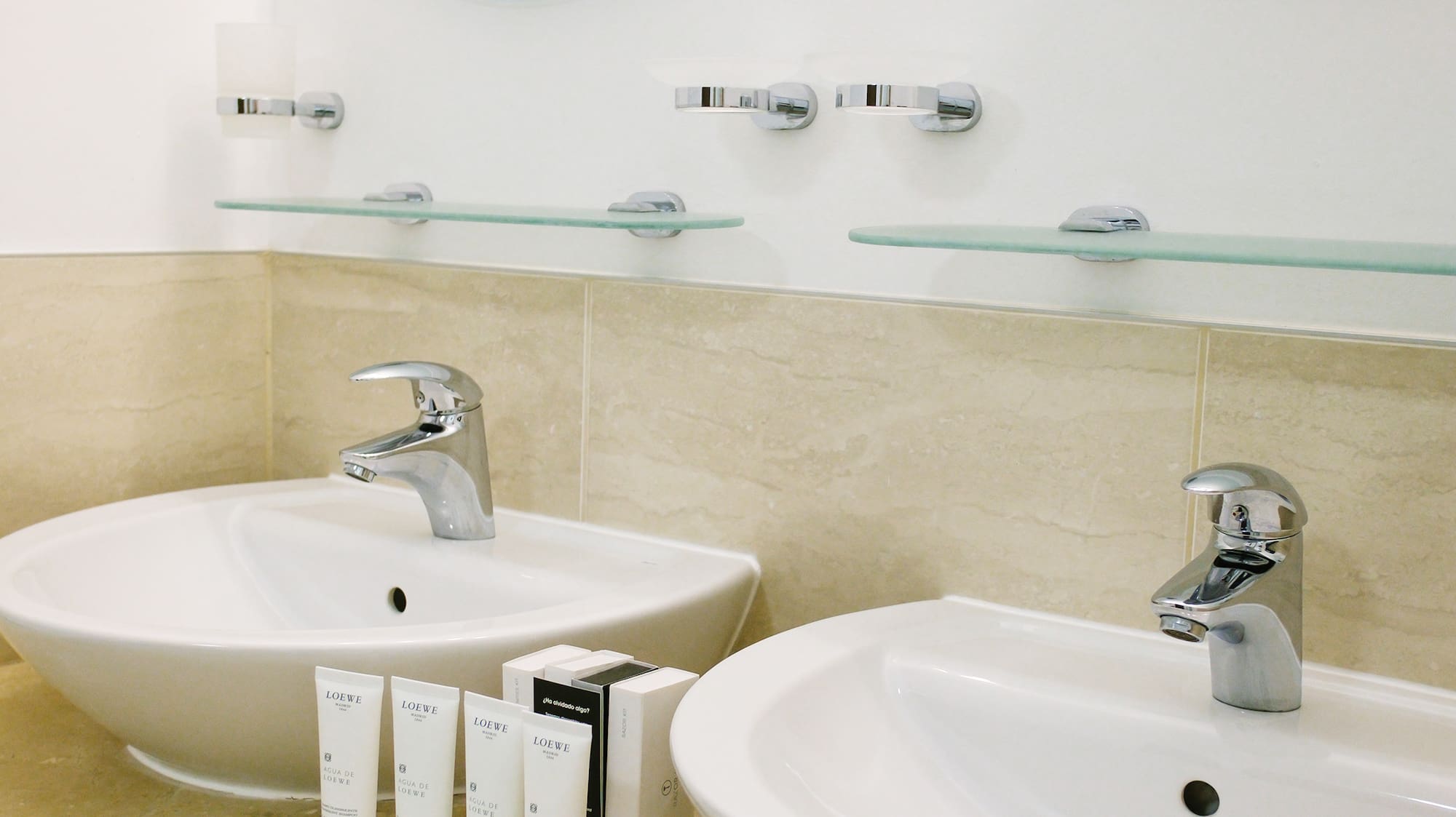 a bathroom with two sinks and mirrors