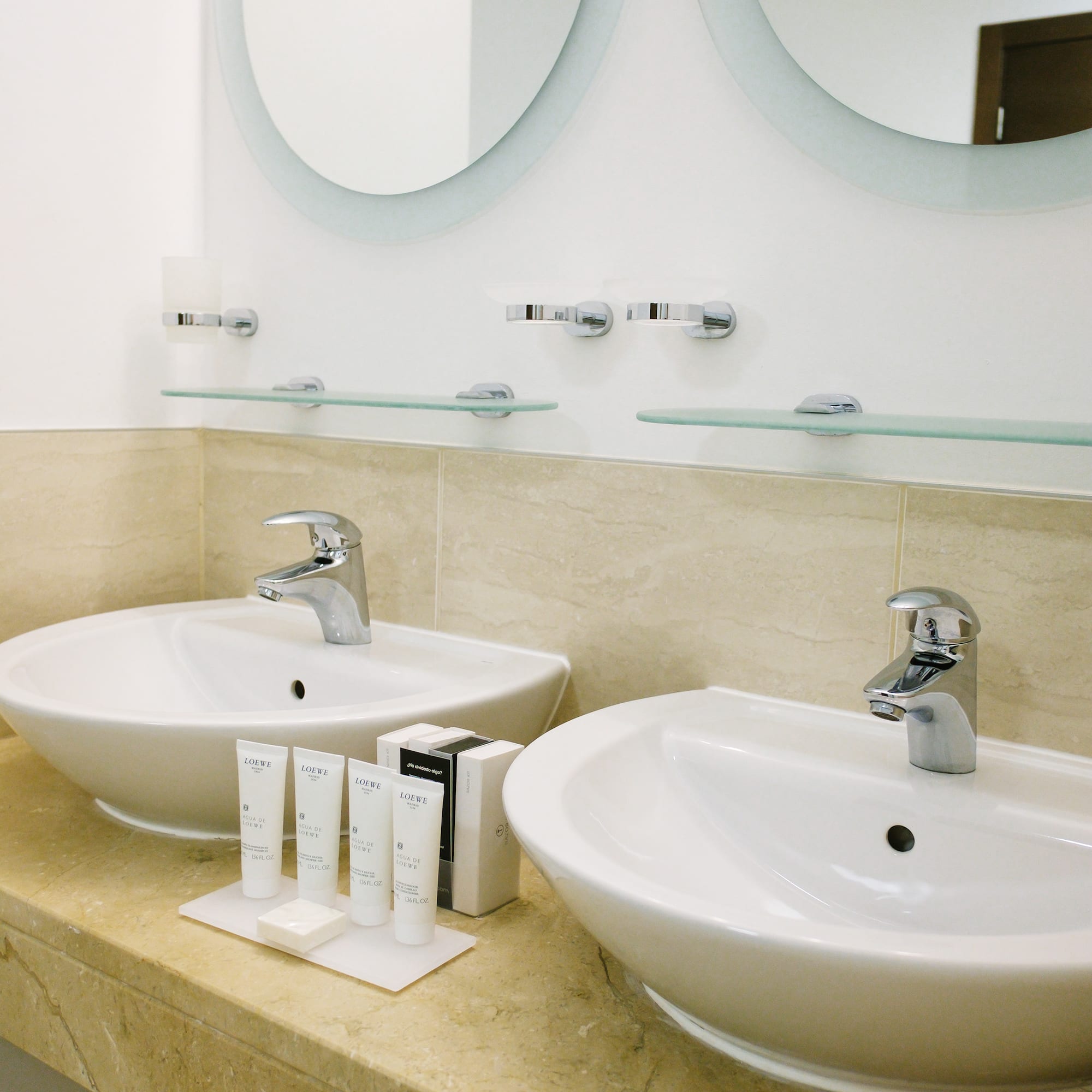 a bathroom with two sinks and mirrors
