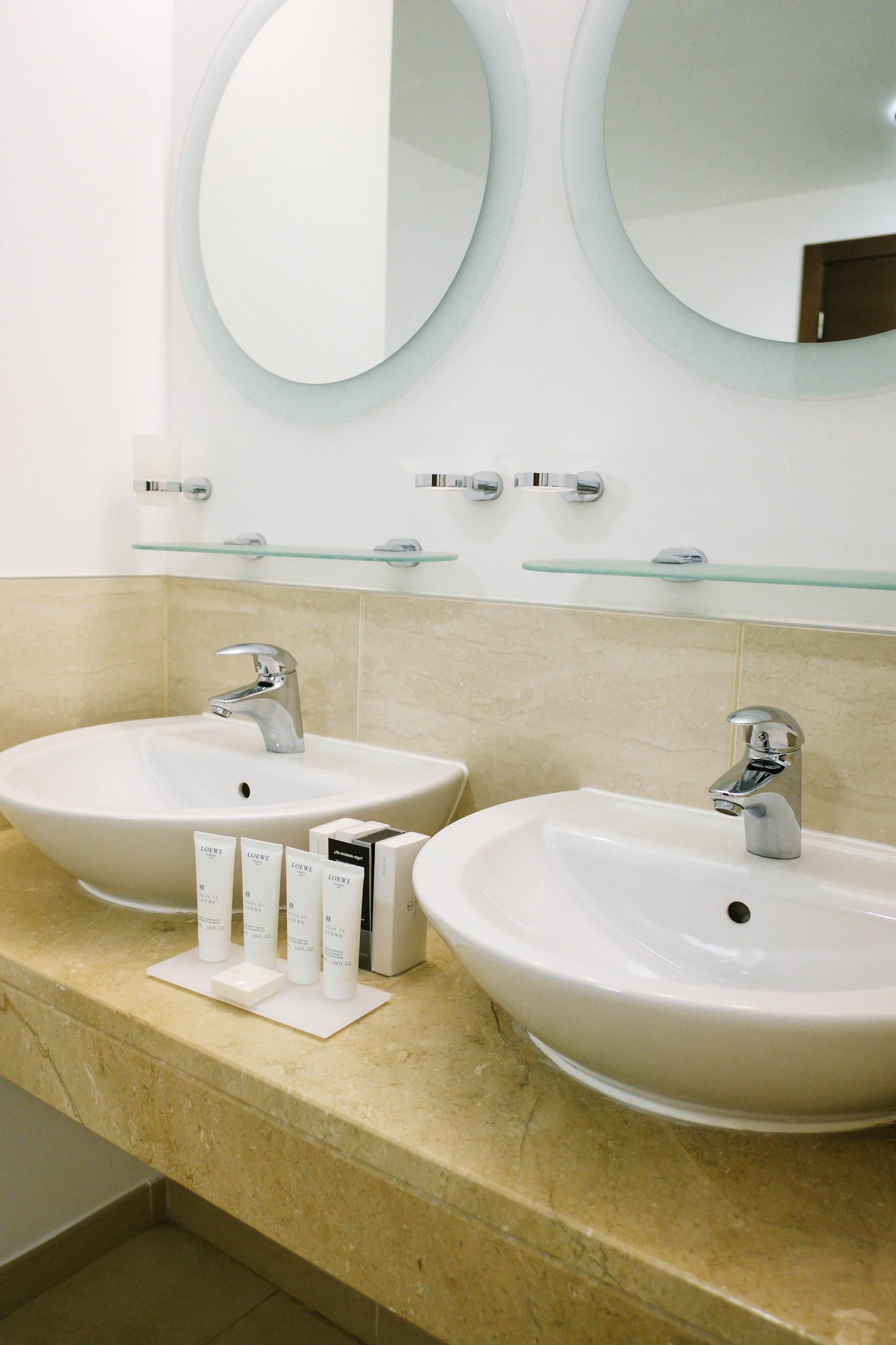 a bathroom with two sinks and mirrors