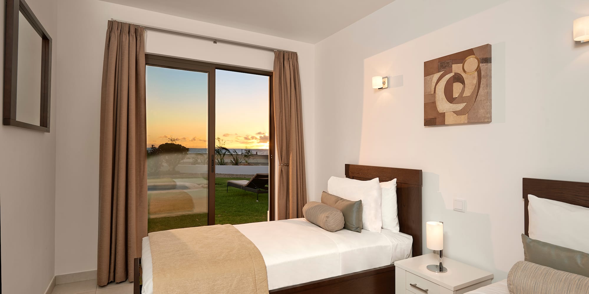 a bedroom with a window and a view of the ocean