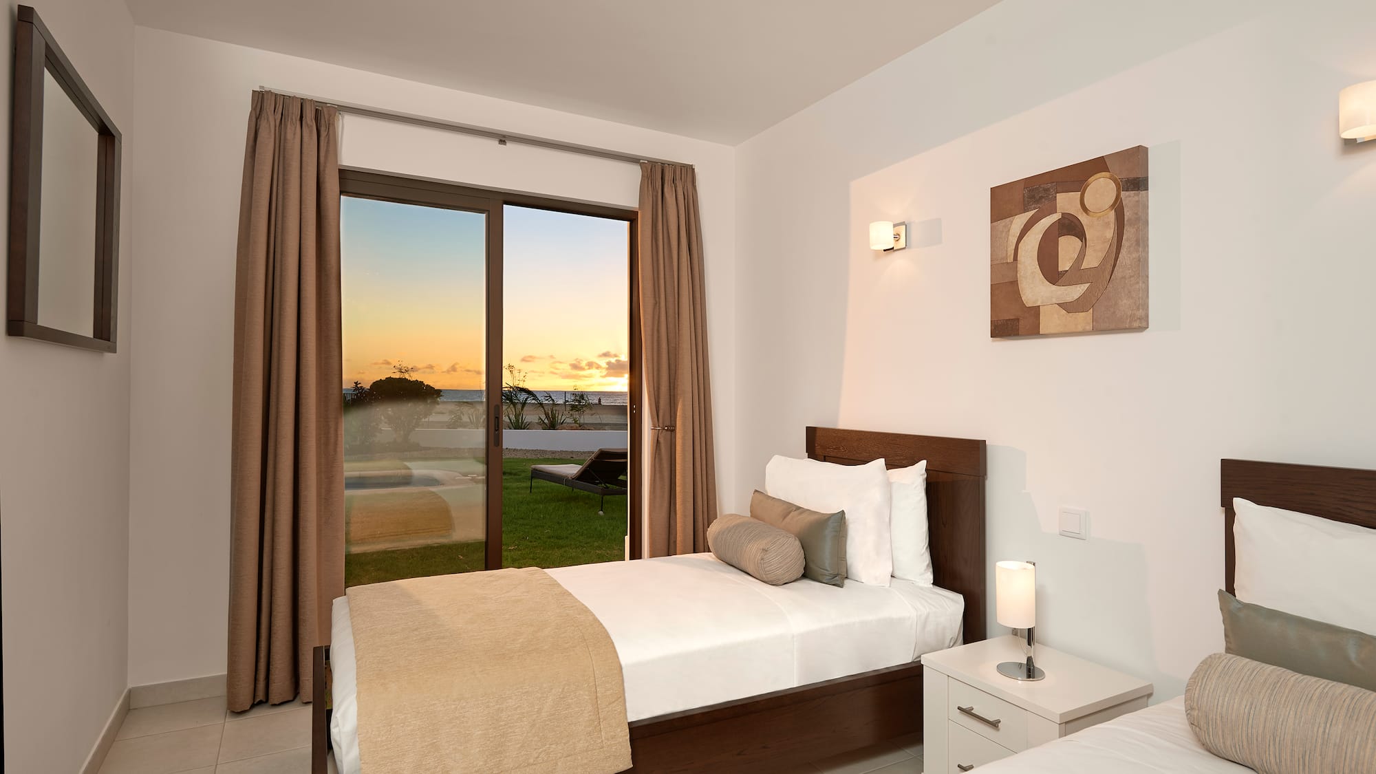 a bedroom with a window and a view of the ocean
