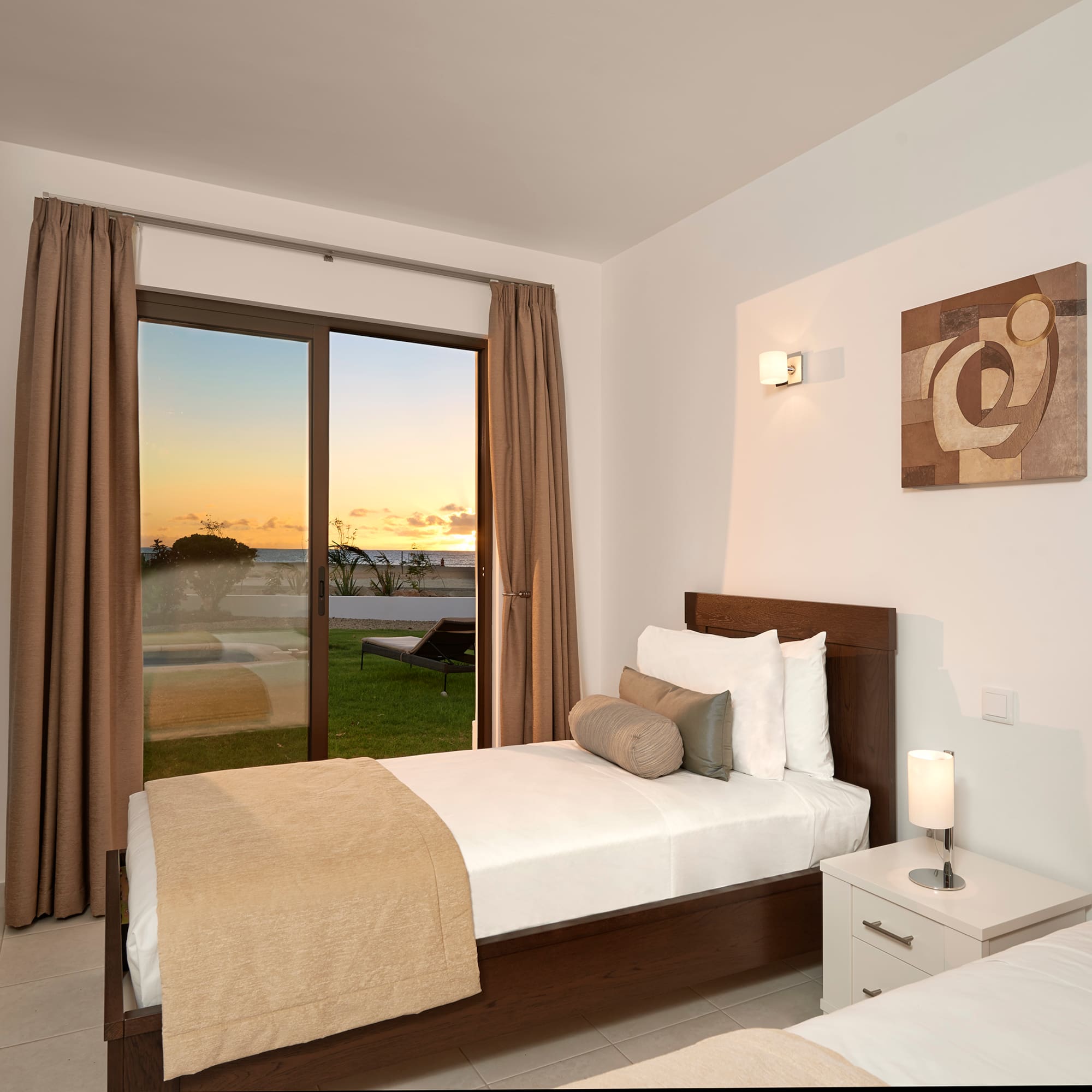 a bedroom with a window and a view of the ocean