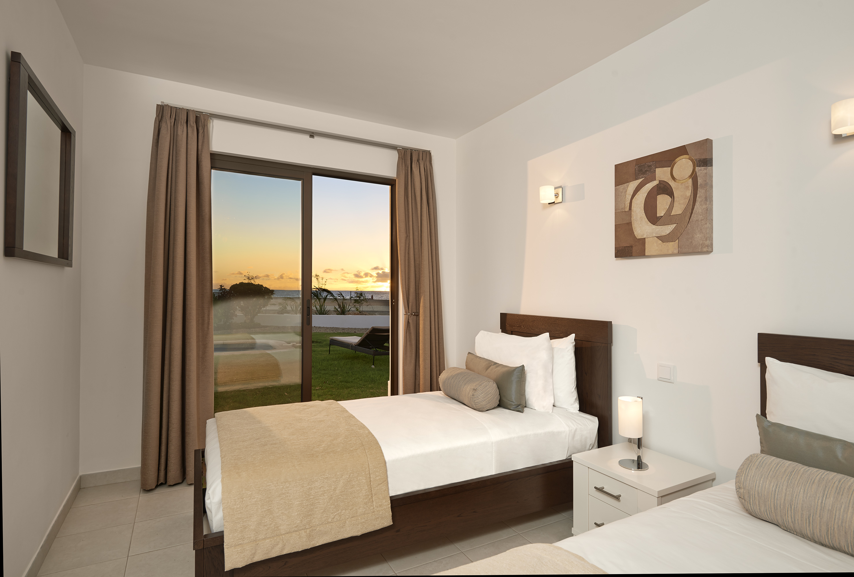 a bedroom with a window and a view of the ocean