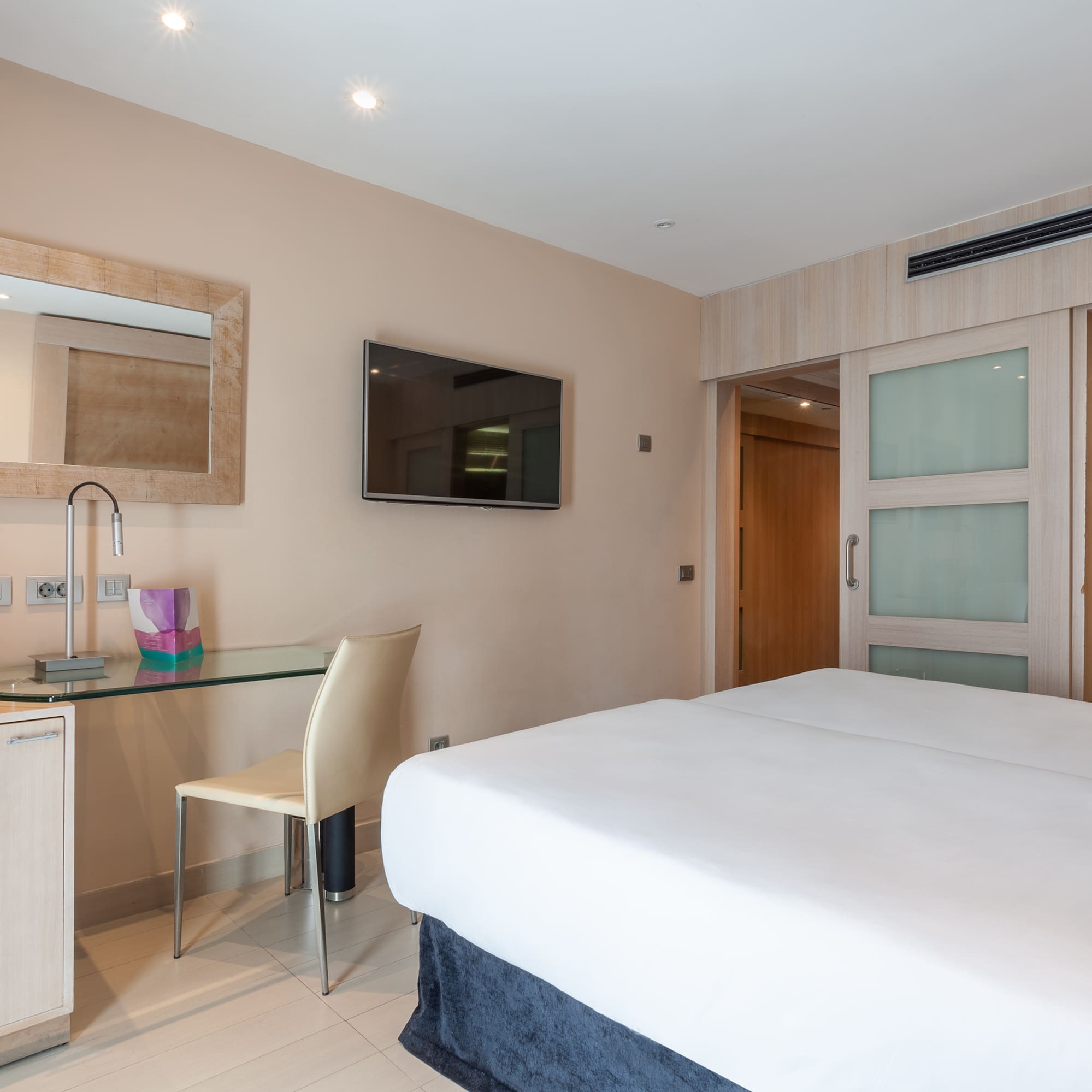 a room with a bed and a desk