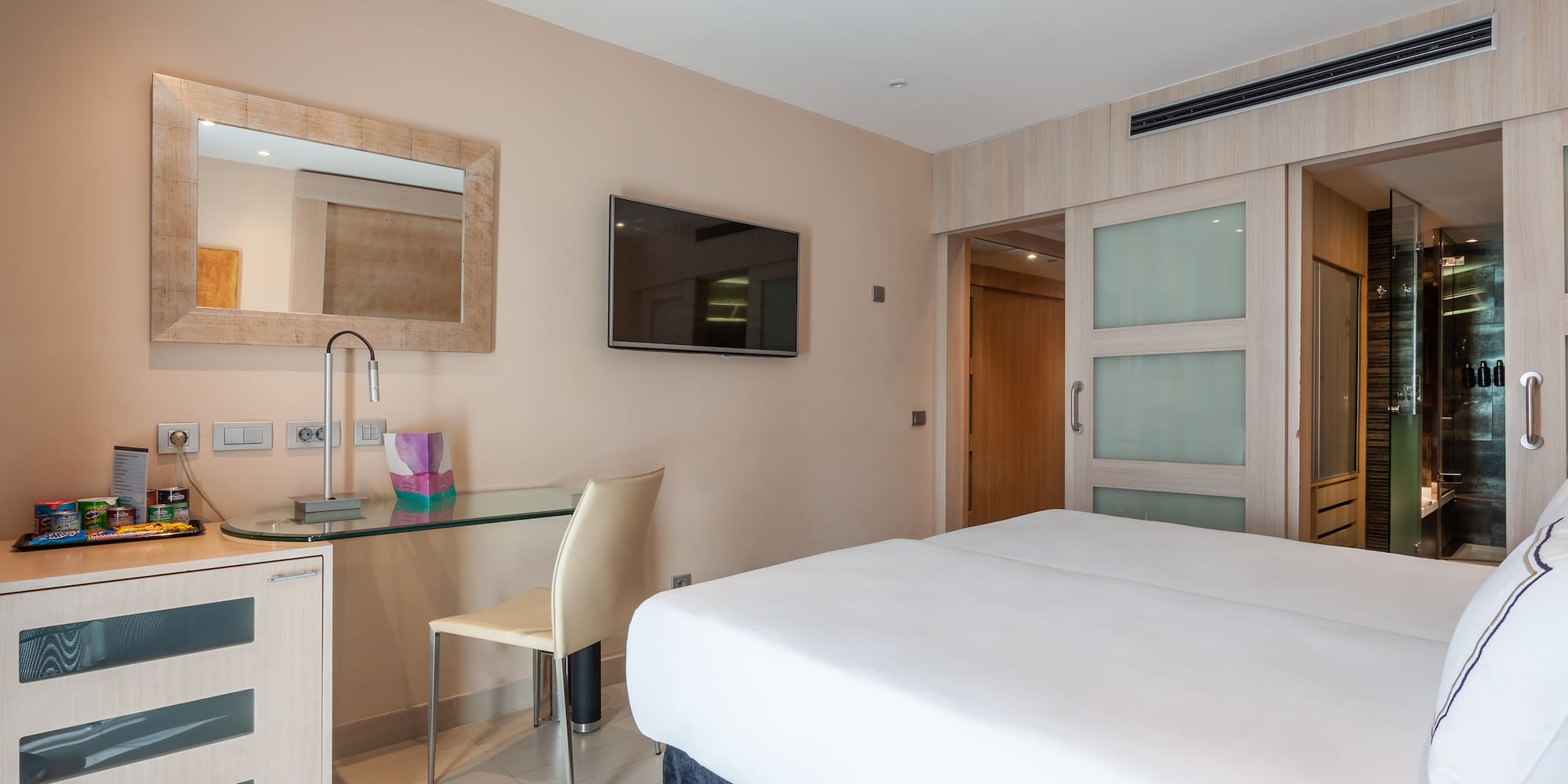 a room with a bed and a desk